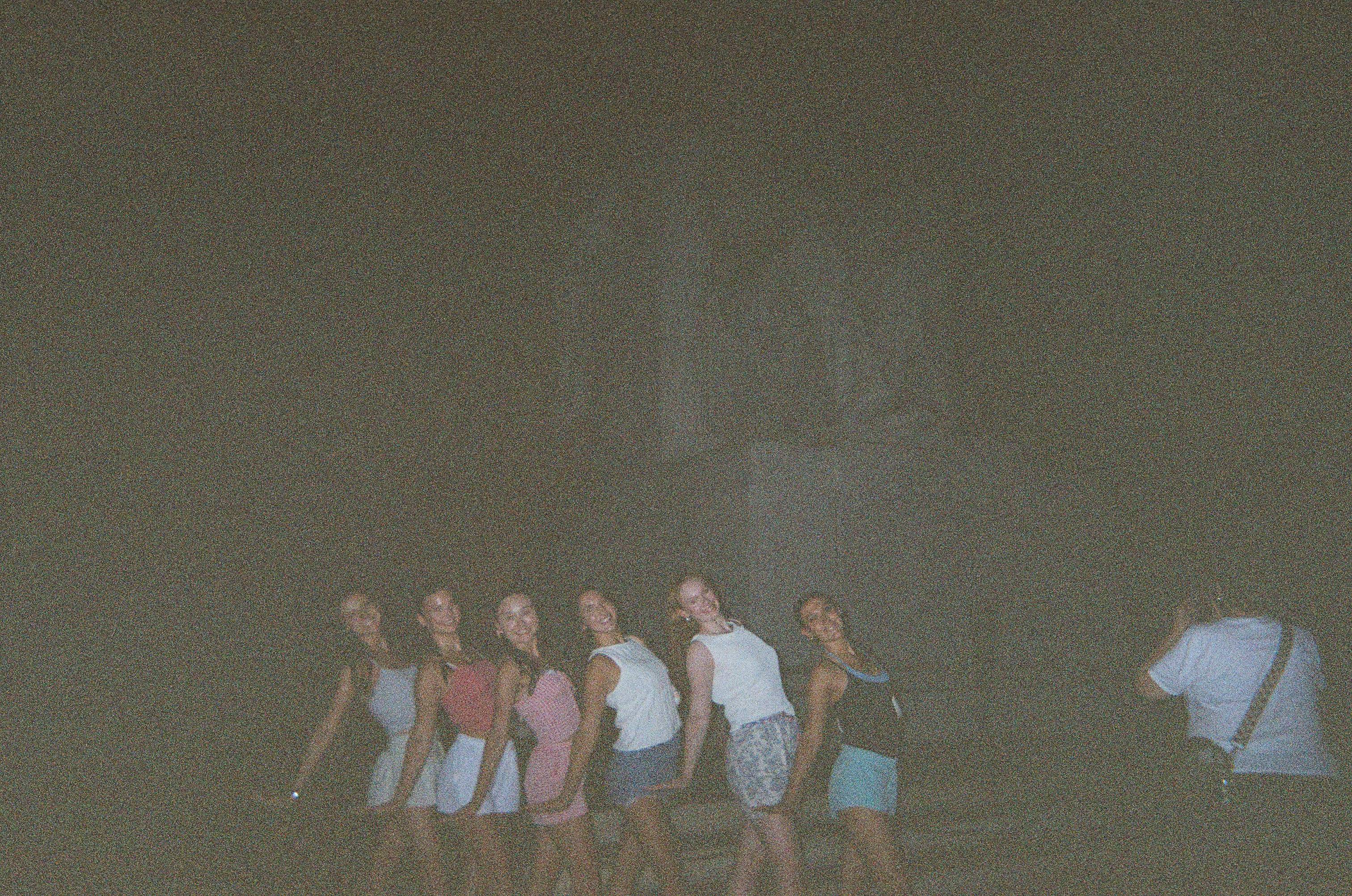 strutters pose in front of Lincoln memorial at night
