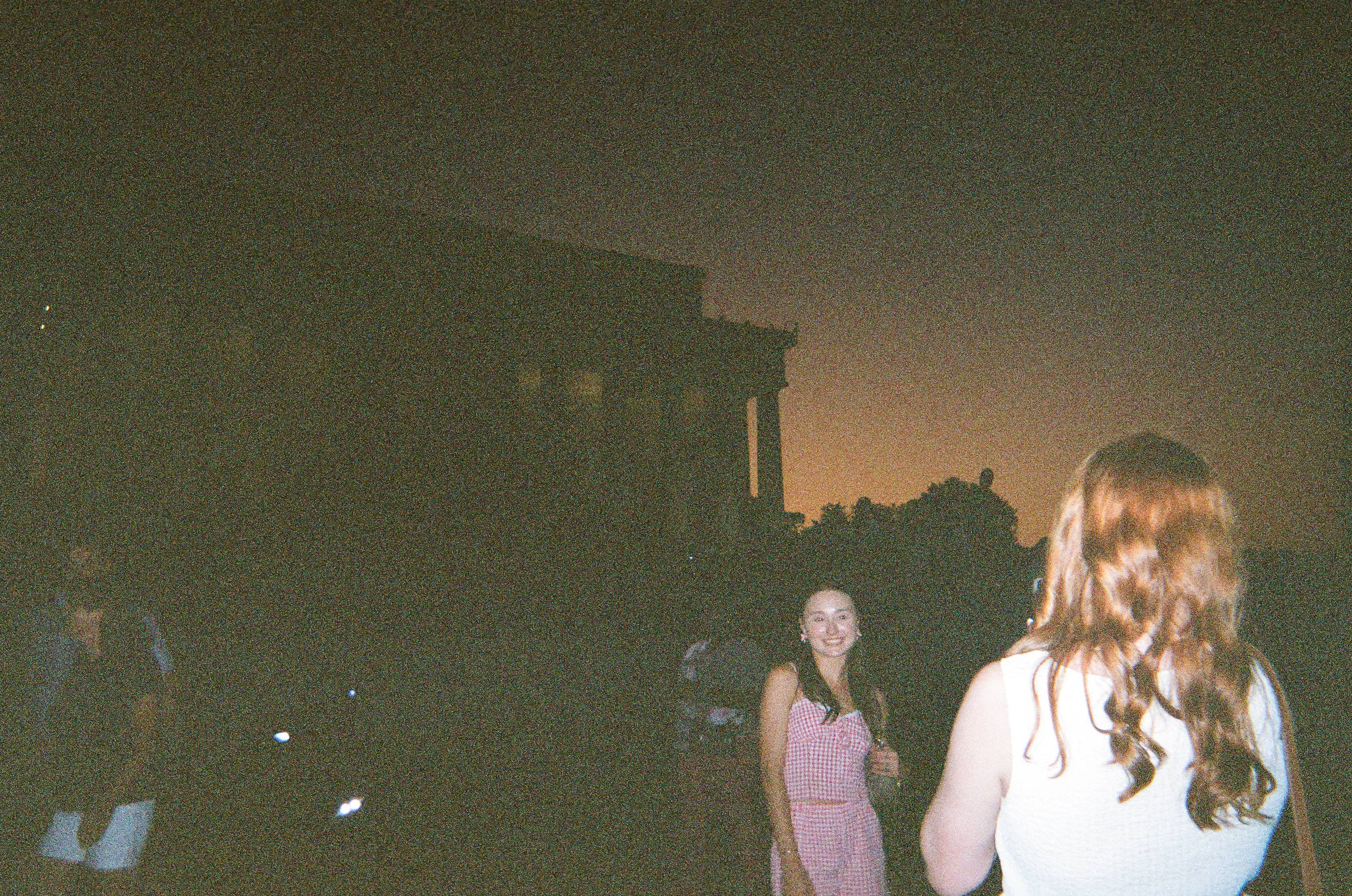 student poses during sunset