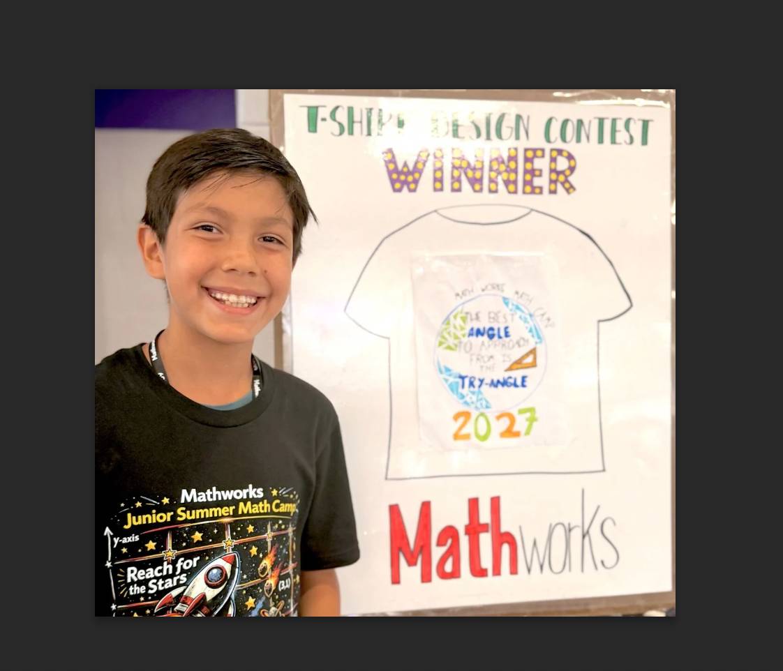 Student standing next to winning T-shirt design.