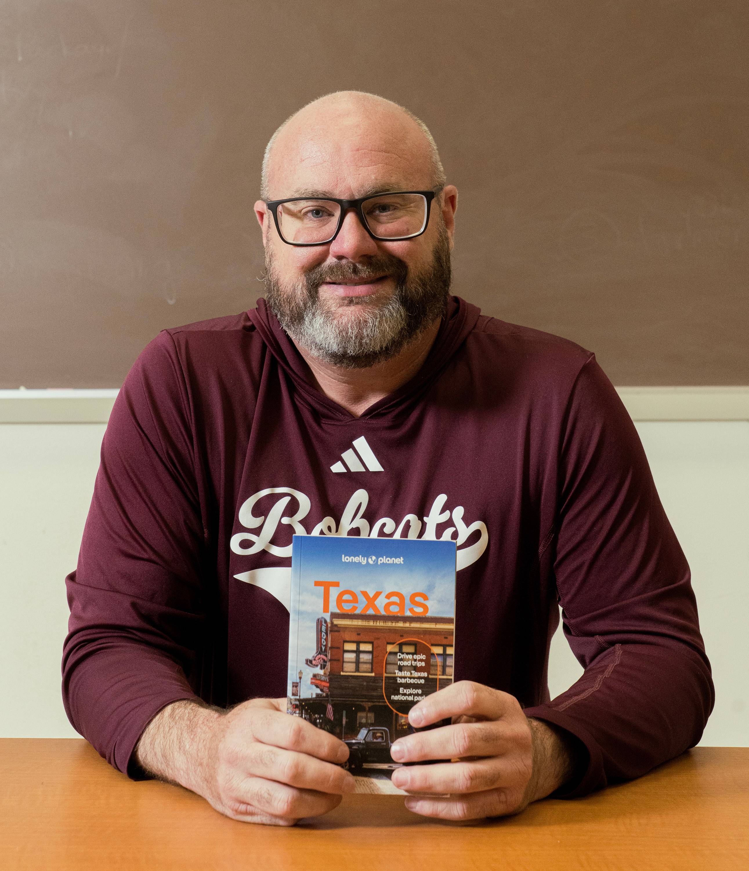 Dale Blasingame holding a copy of Lonely Planet Texas.