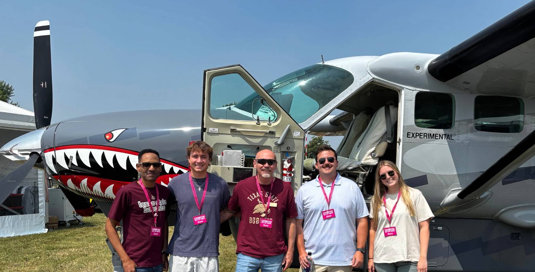 aviation science photo of two students, two faculty, and a flight partner instructor at 2026 oshkosh air show