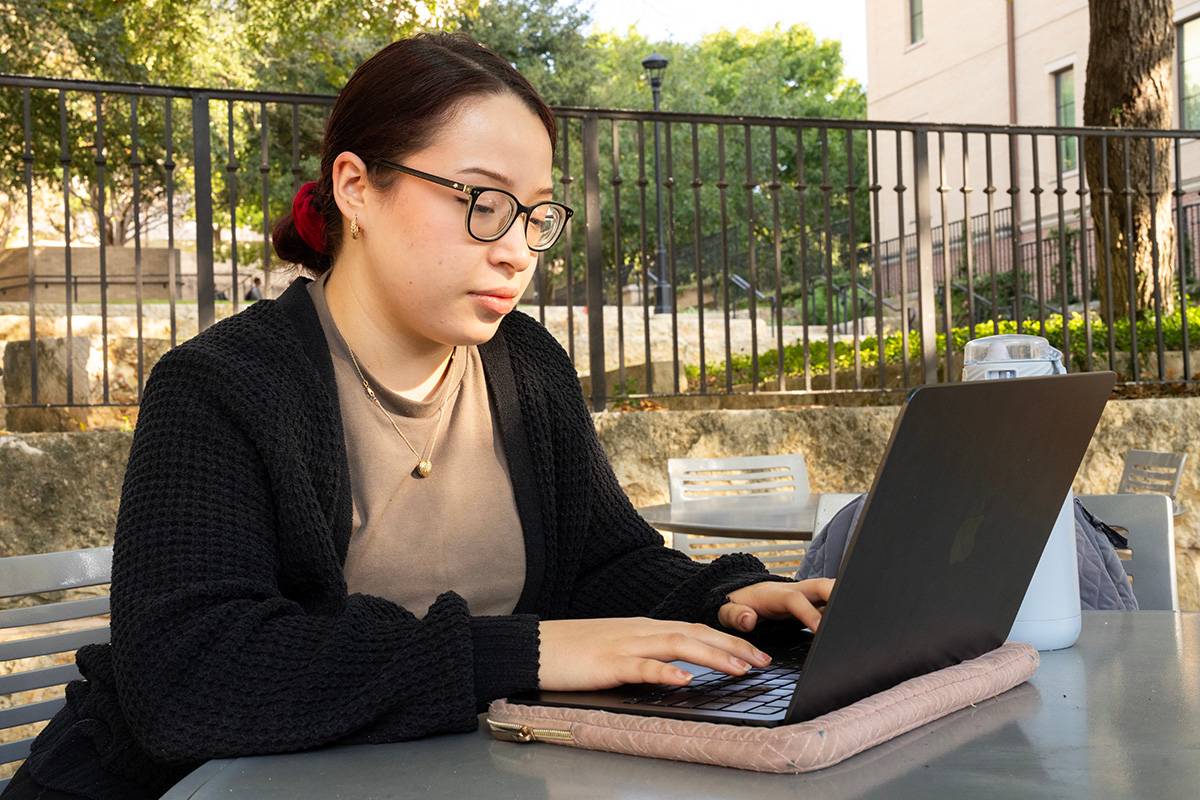 Student studying on a laptop.