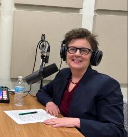 photo of Dr. Cathy Cherrstrom during a podcast with a mic