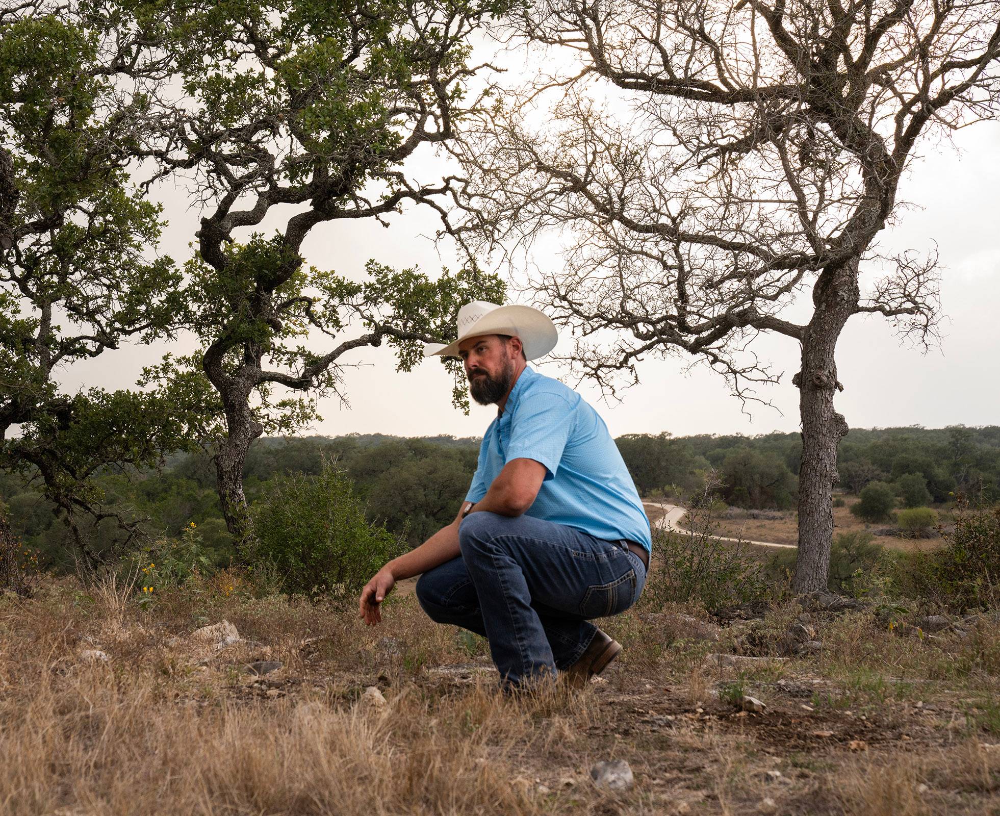 Texas State professor examines the soil at Freeman Ranch.