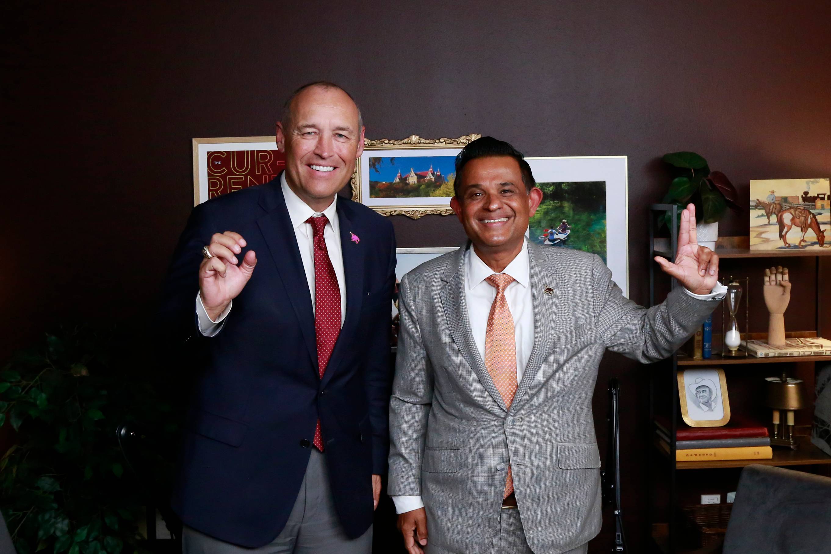 university president kelly damphousse and vp of research shreek mandayam do the states up pose