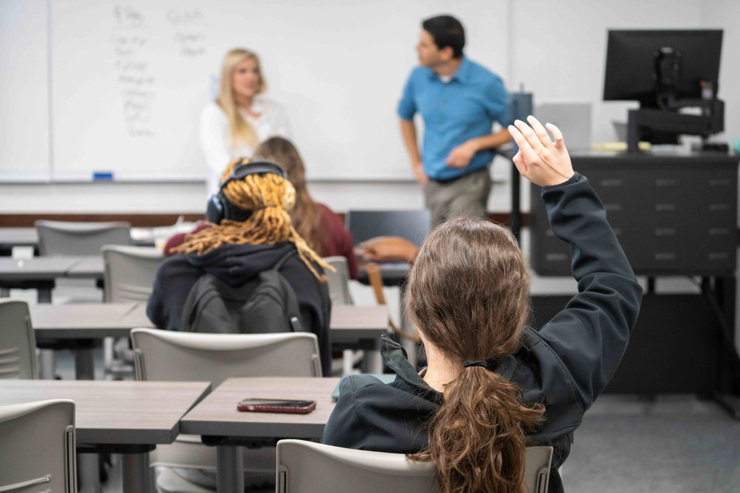 student raises hand in class