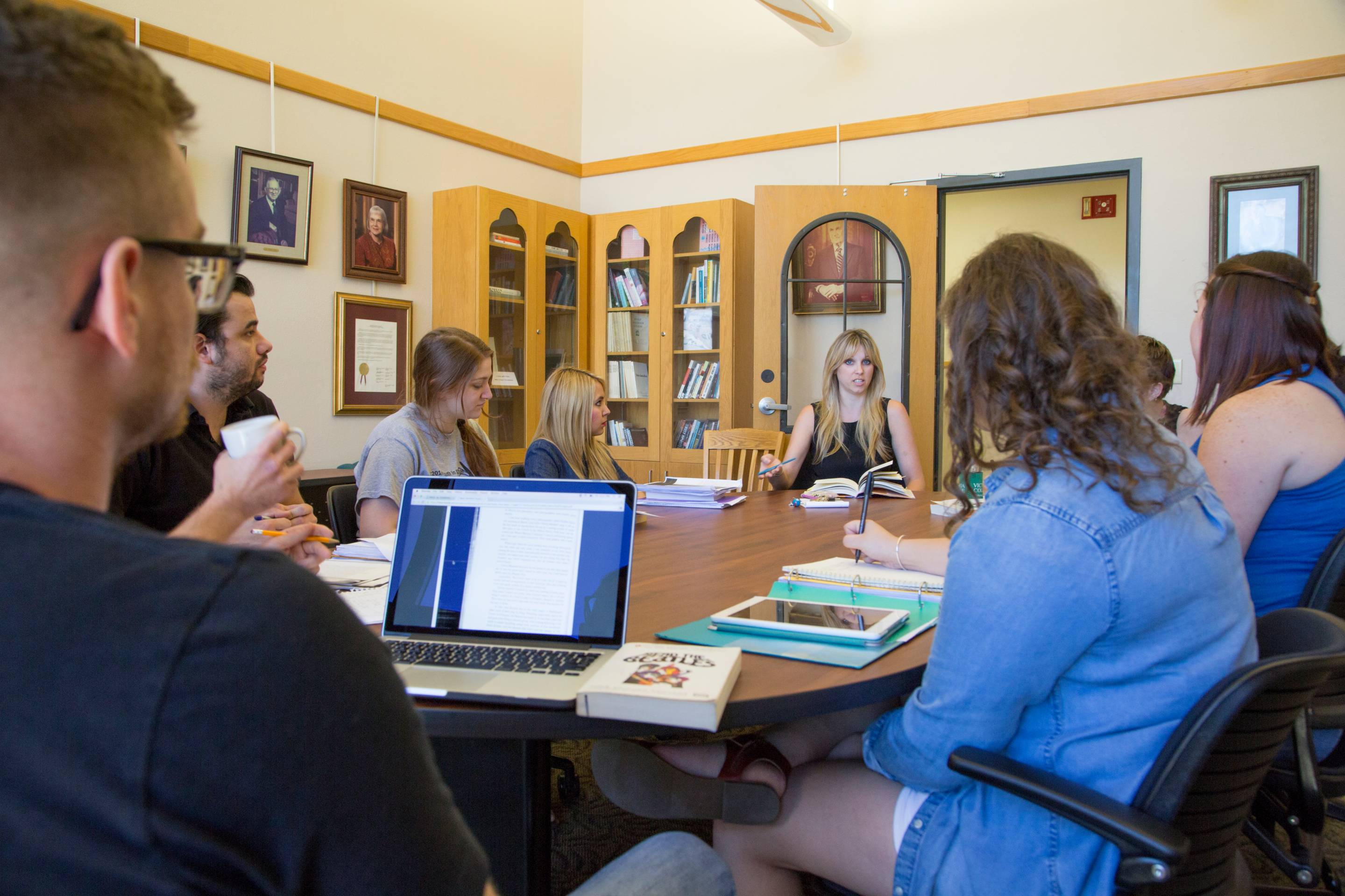 a teacher talking to students in conference room