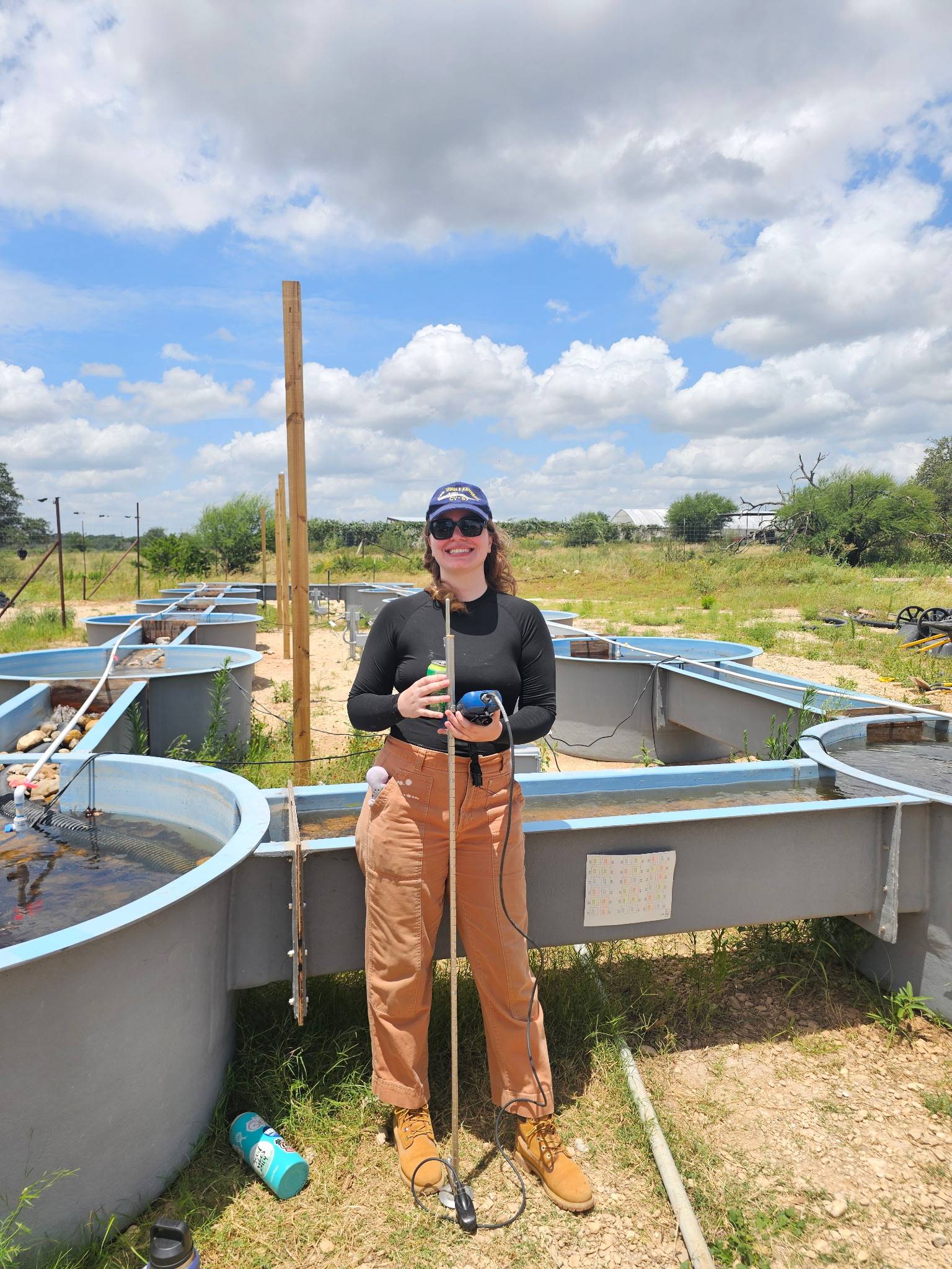 woman standing next to controlled stream environment outside