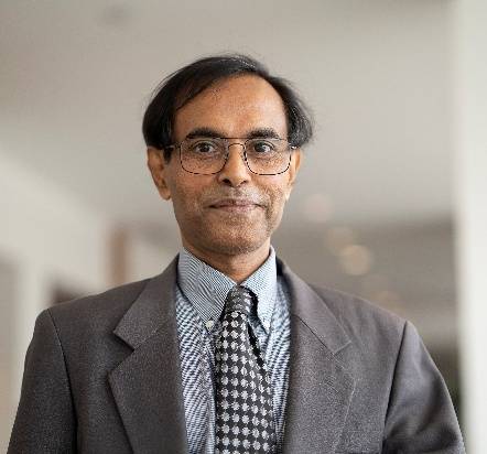Dr. Dey standing in a room.