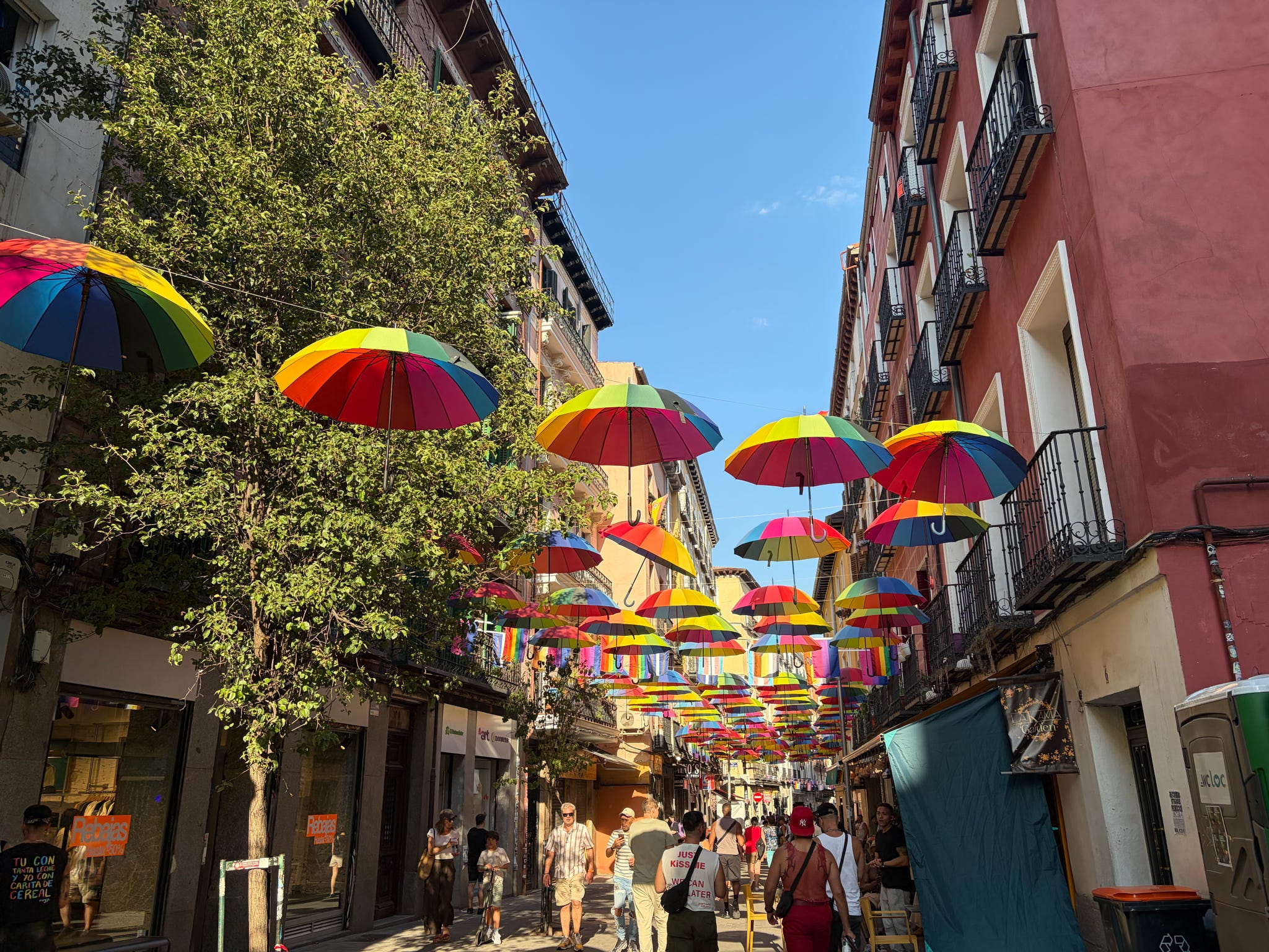 colorful umbrellas hanging above street in Madrid