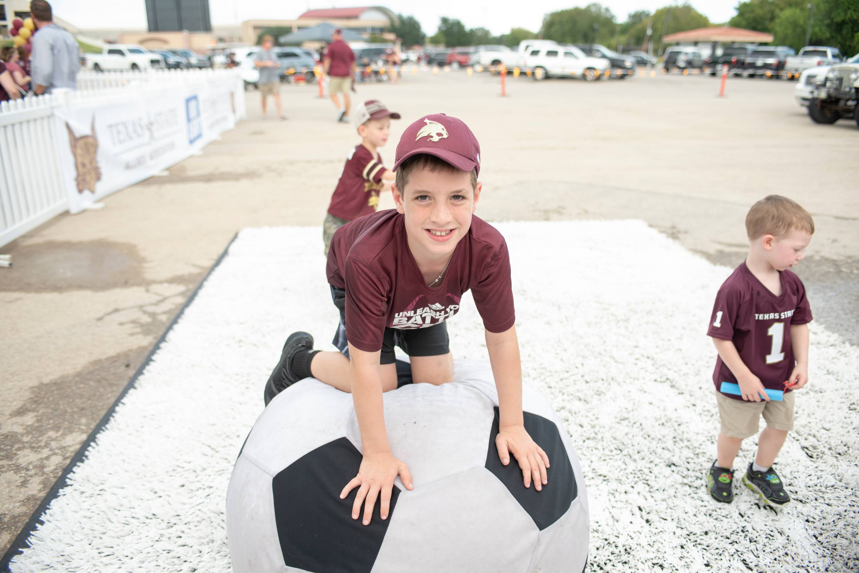 Boy climbing on soccer ball