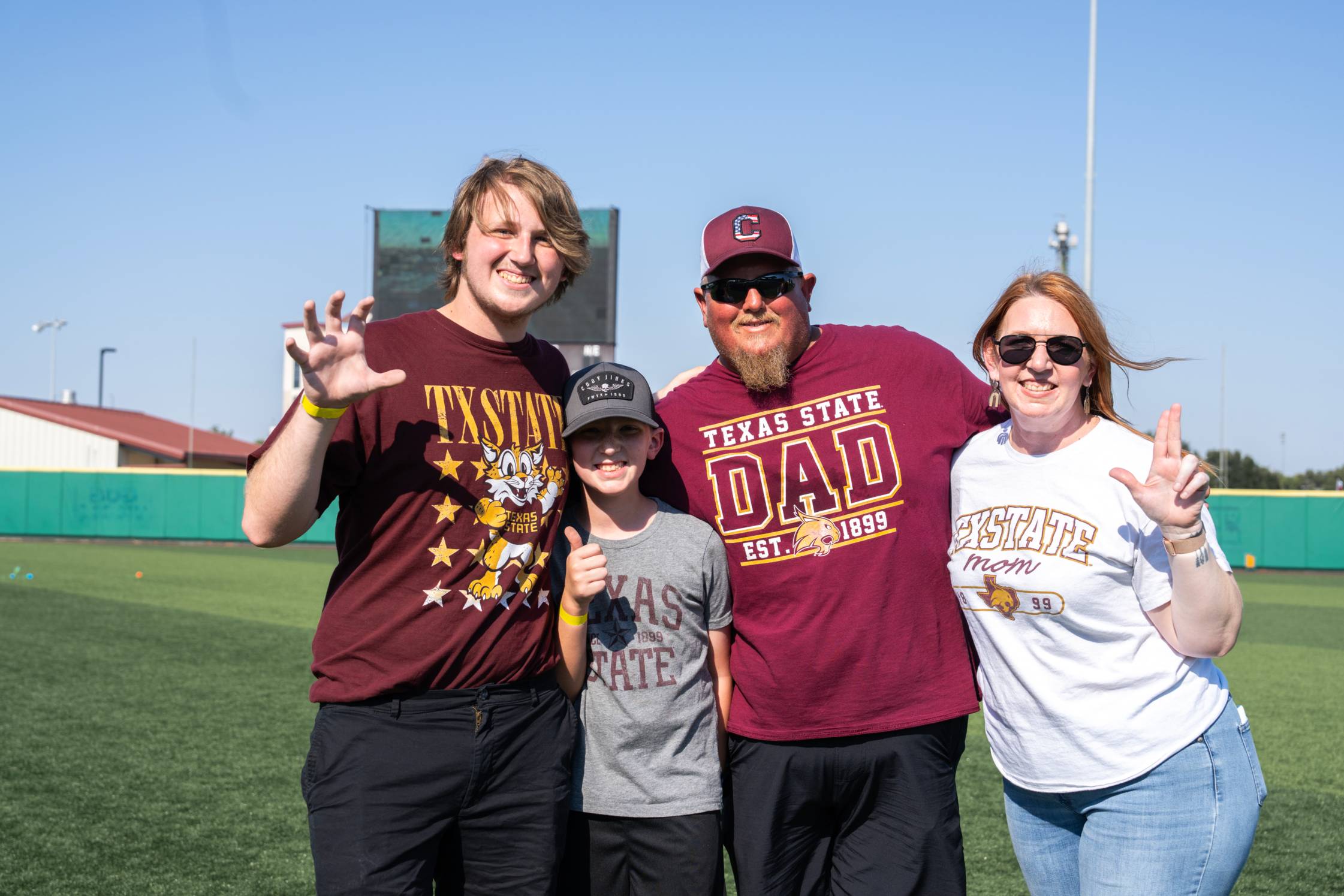 Family posing at the baseball field