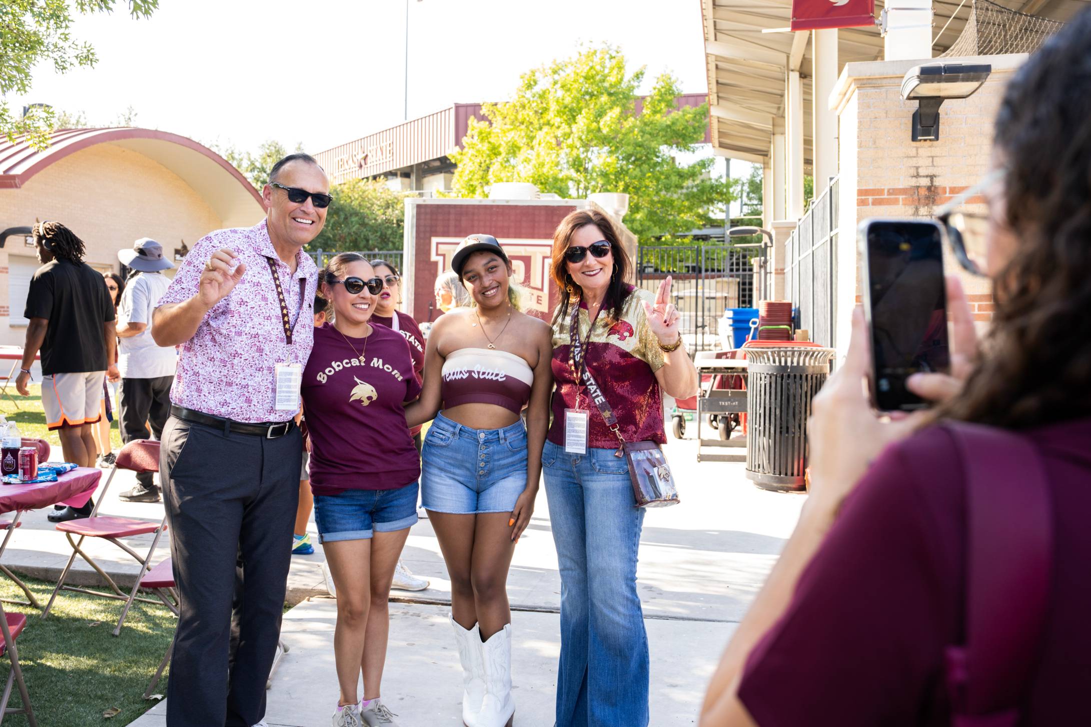 Family posing with the president and first lady of Texas State