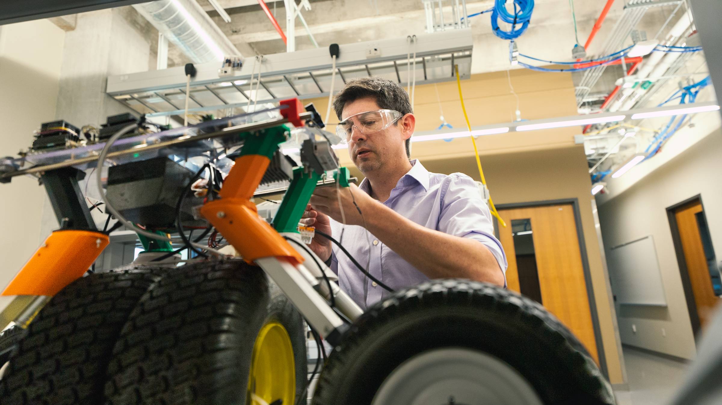 Dr. Damian Valles works on a fire rover in his lab