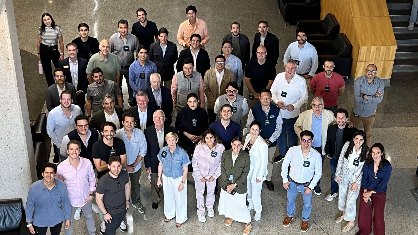 a group of professionally dressed people pose for photo 