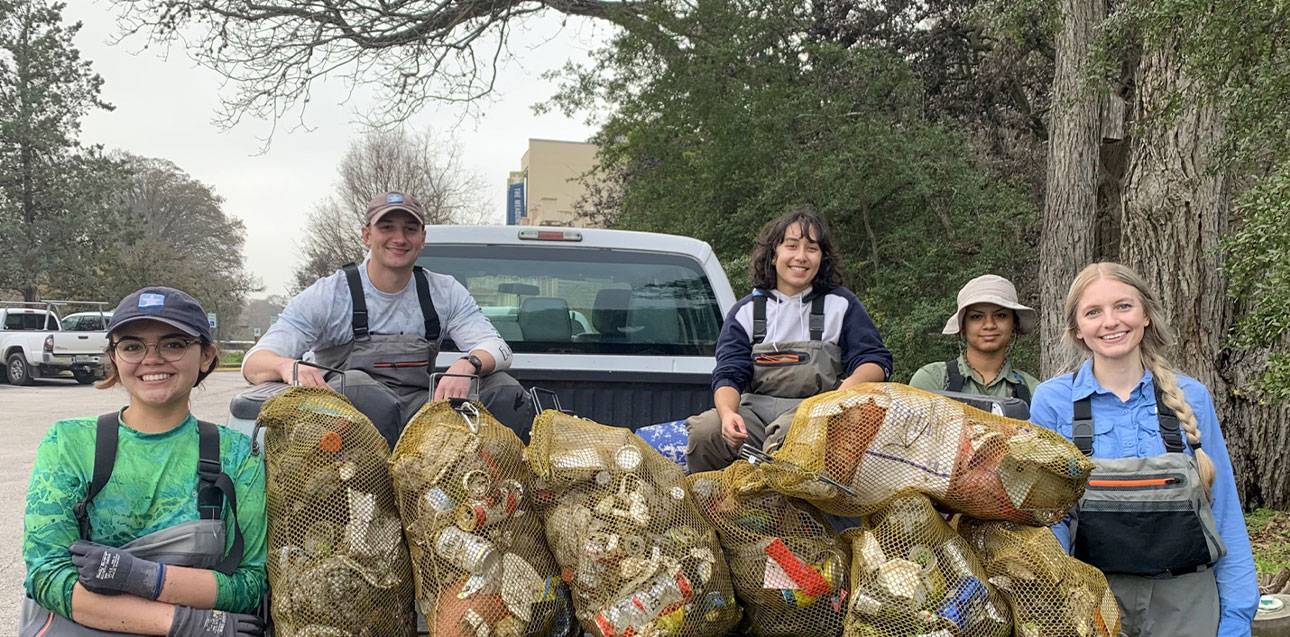 Habitat Field Crew Technicians remove litter from a morning shift in the San Marcos River in fall 2023.