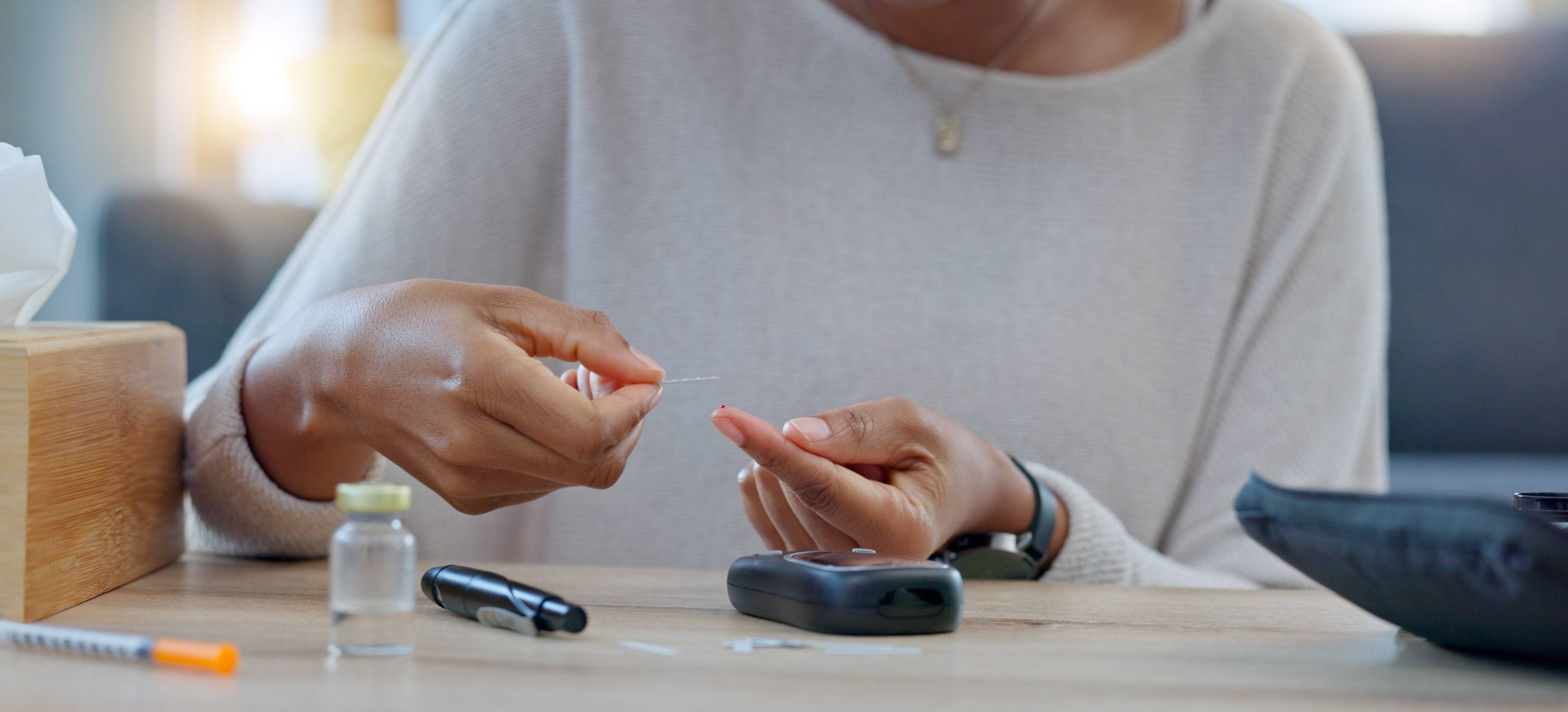 woman taking blood prick test for diabetes