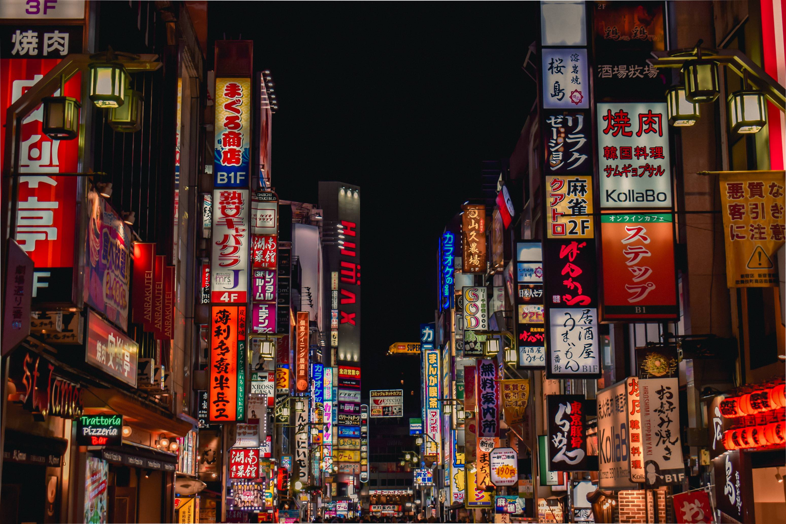 Neon Japanese signs lighting up street at night