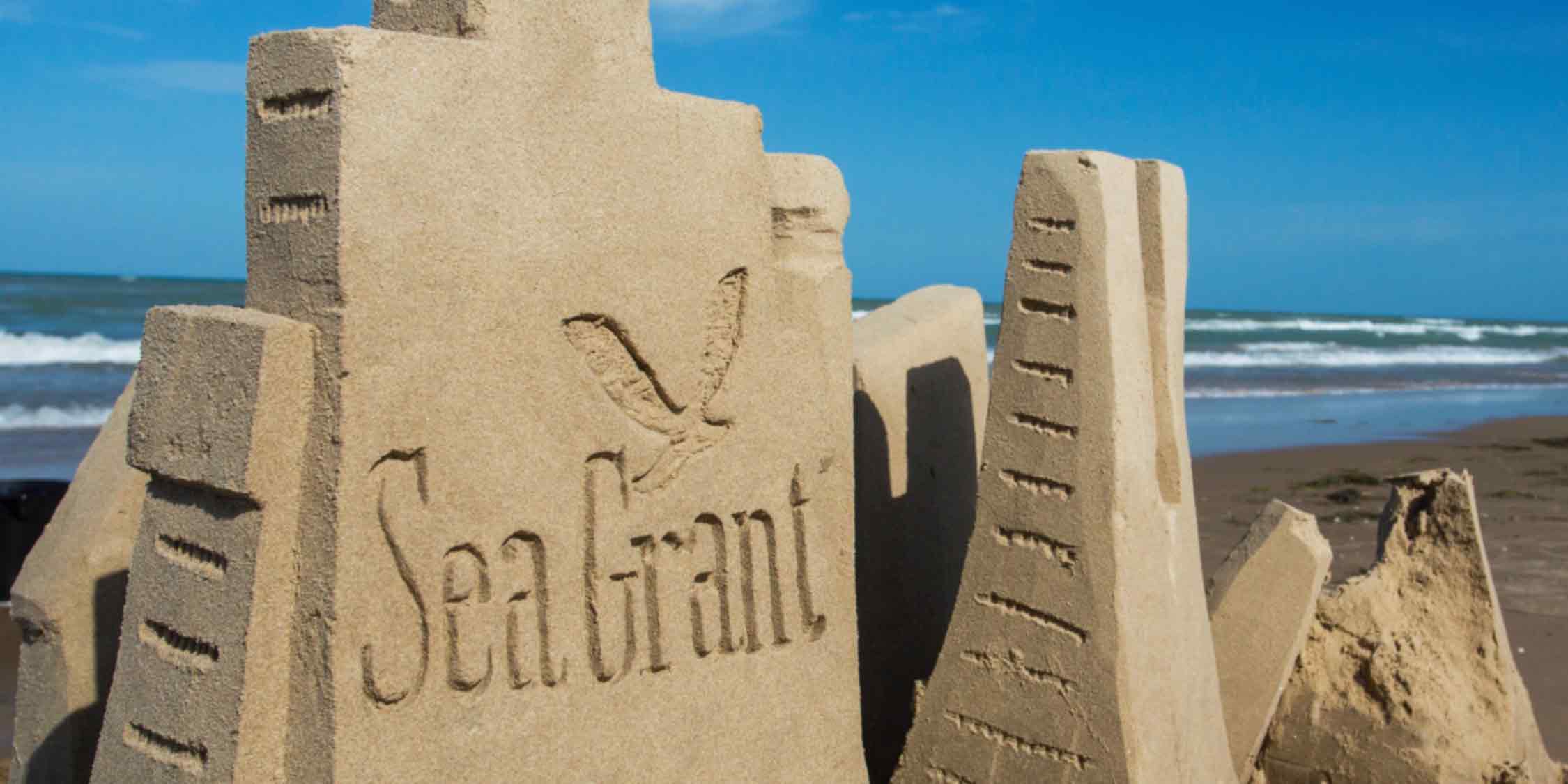 Sand castle with Sea Grant logo