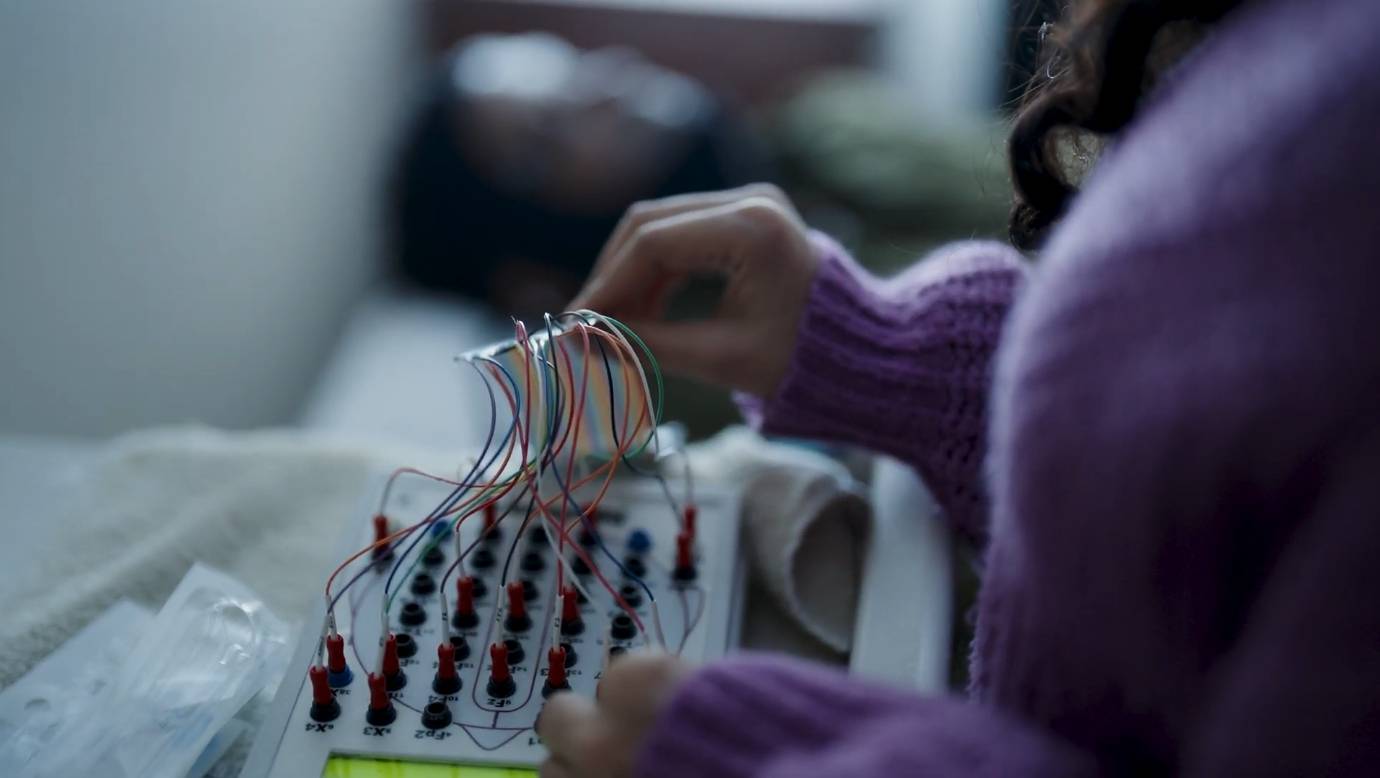 TXST student researcher working on electronics board