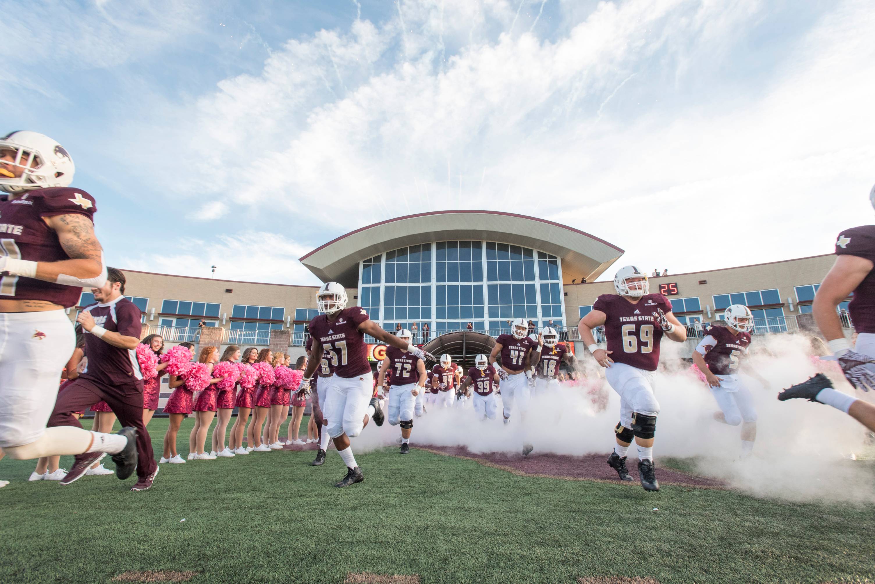 football team running out onto the field. 