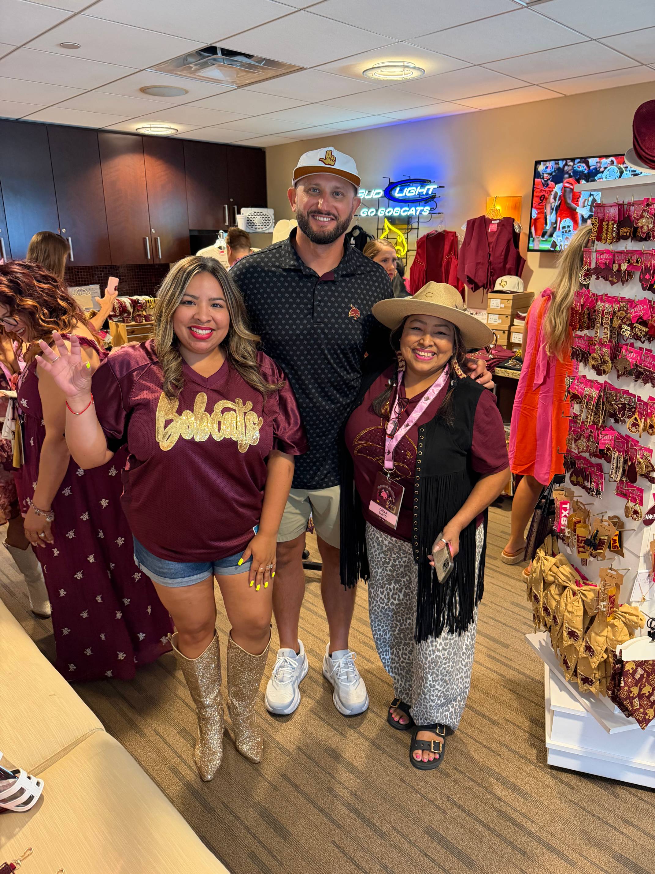man and two women pose for photo in store
