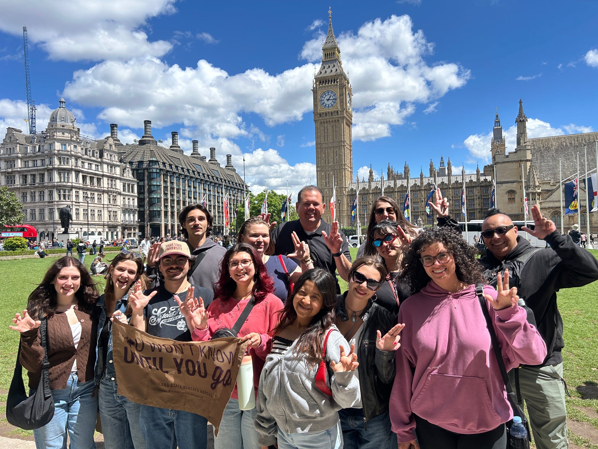 a group of texas state students and staff members standing front of the Elizabeth Tower - Westminster London