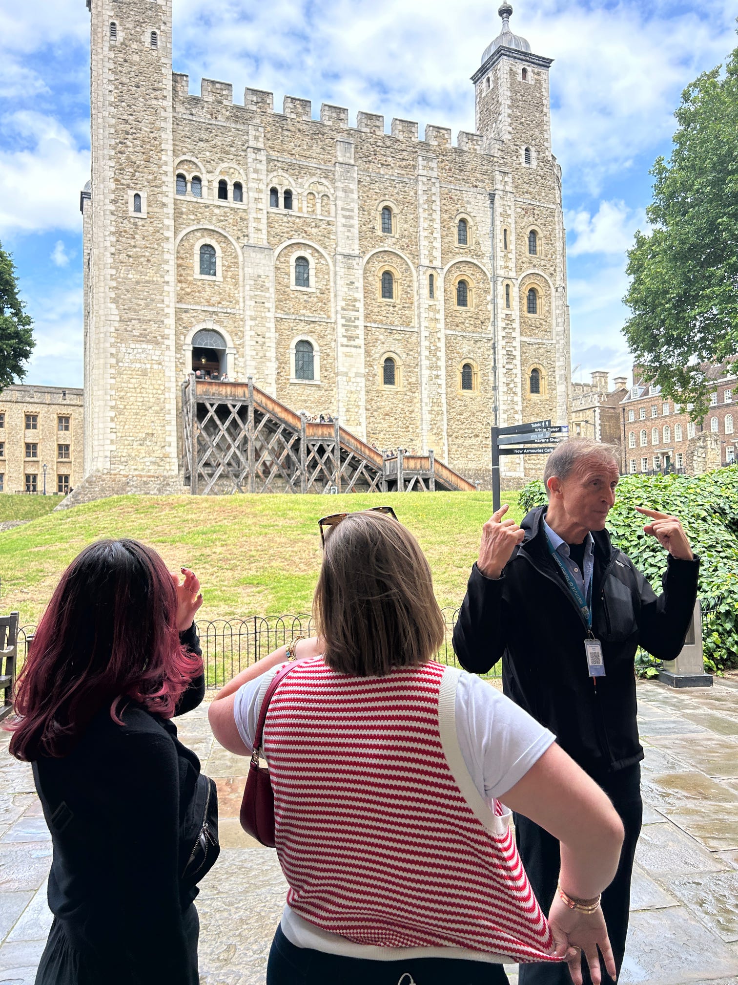a group of texas state students and staff members standing front of the Tower of London
