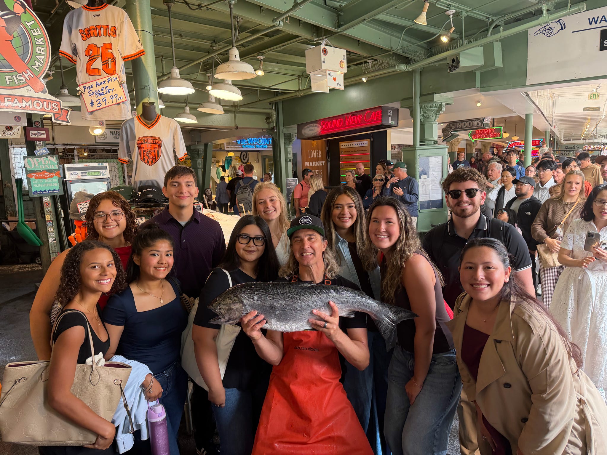 a group of Texas State students and staff members at the Pike Place Fish Market in Seattle 