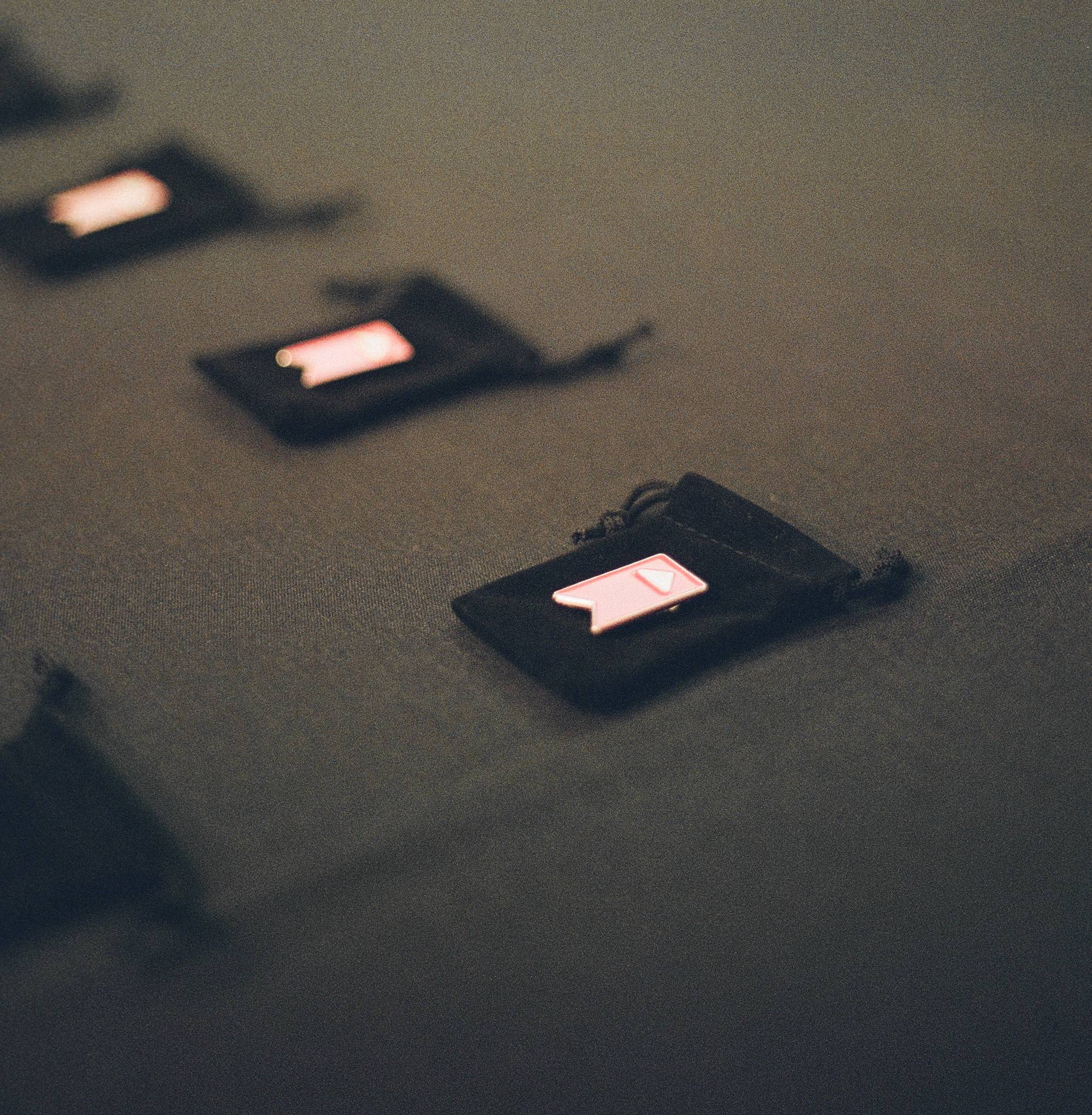 ACUE pins on top of a black tablecloth 