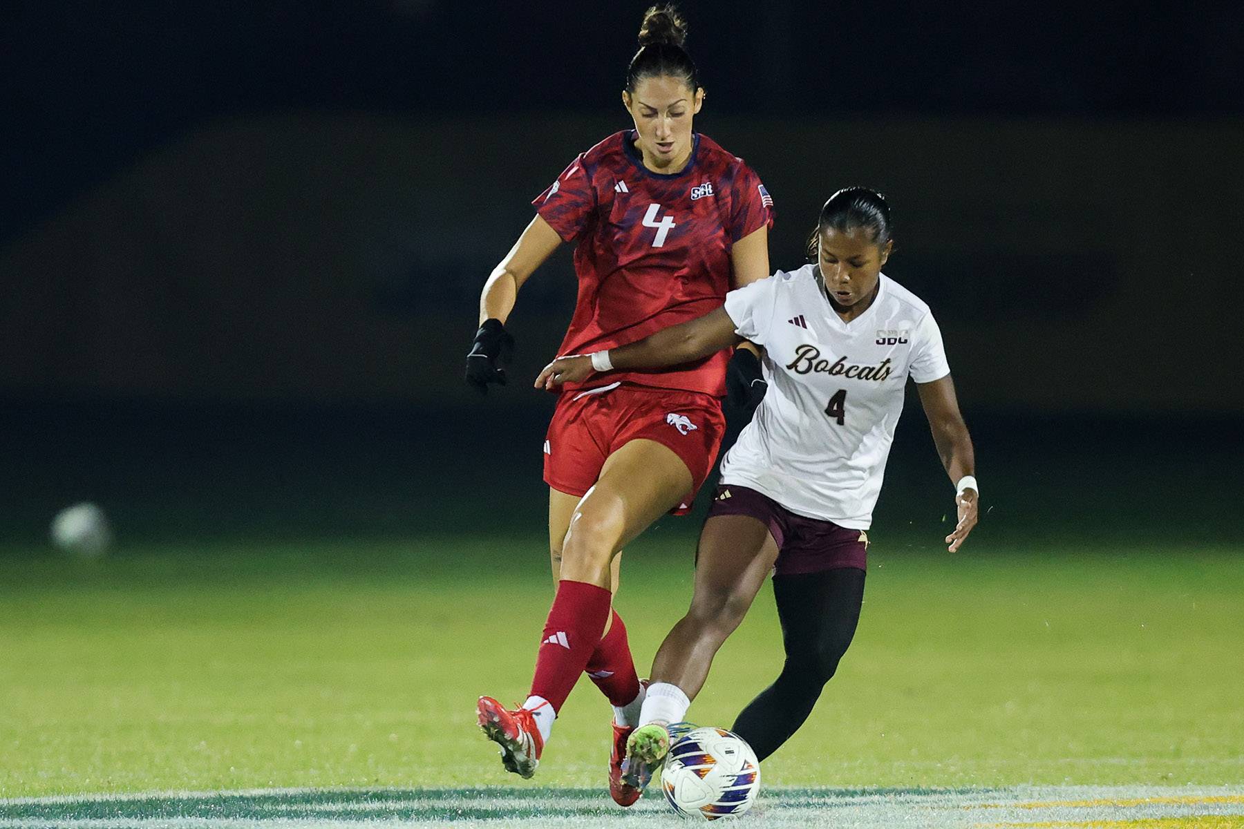 Victoria Meza keeps the ball away from another player.