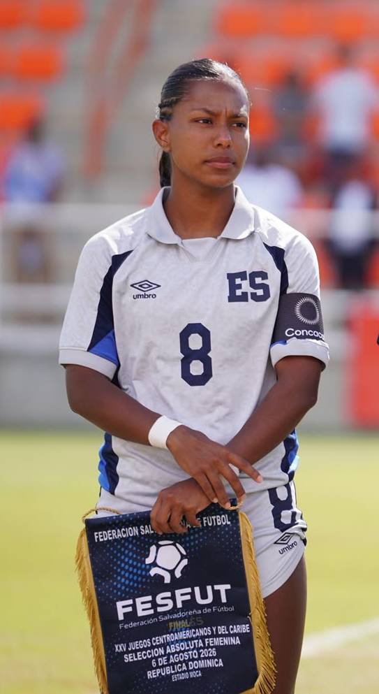 Victoria Meza stands dressed in her uniform playing for El Salvador.