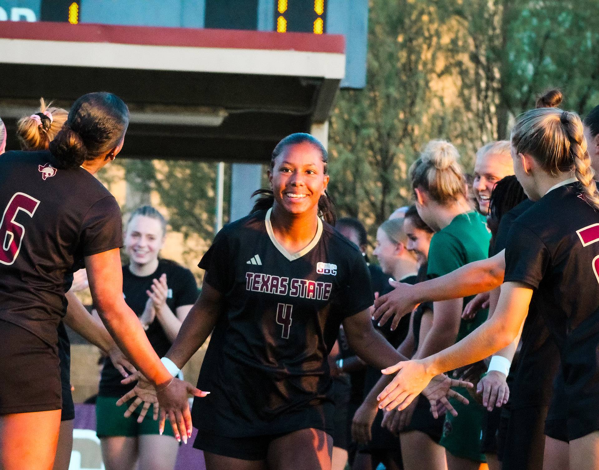 Victoria Meza smiles as she runs onto the pitch.