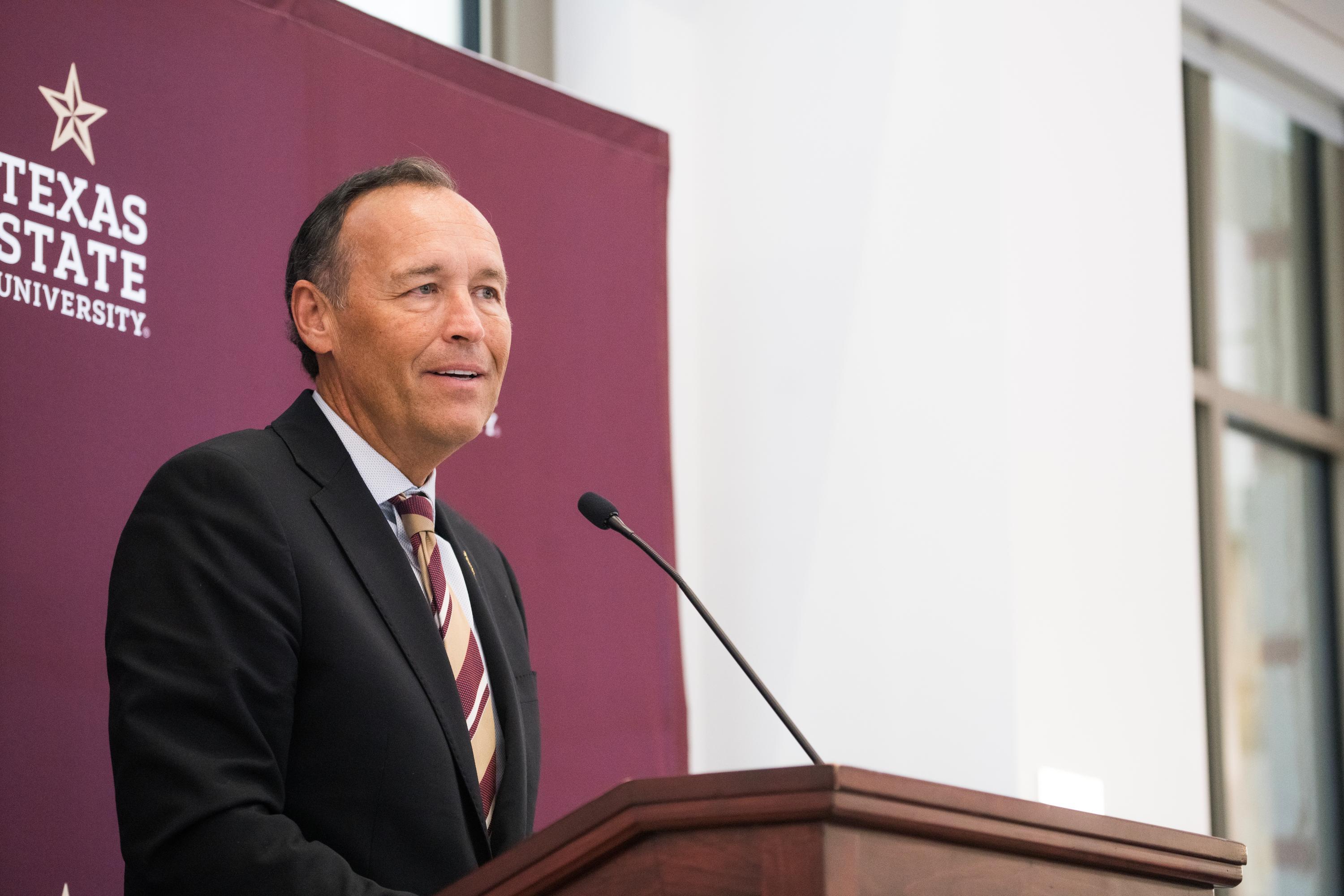 president damphousse speaking at podium