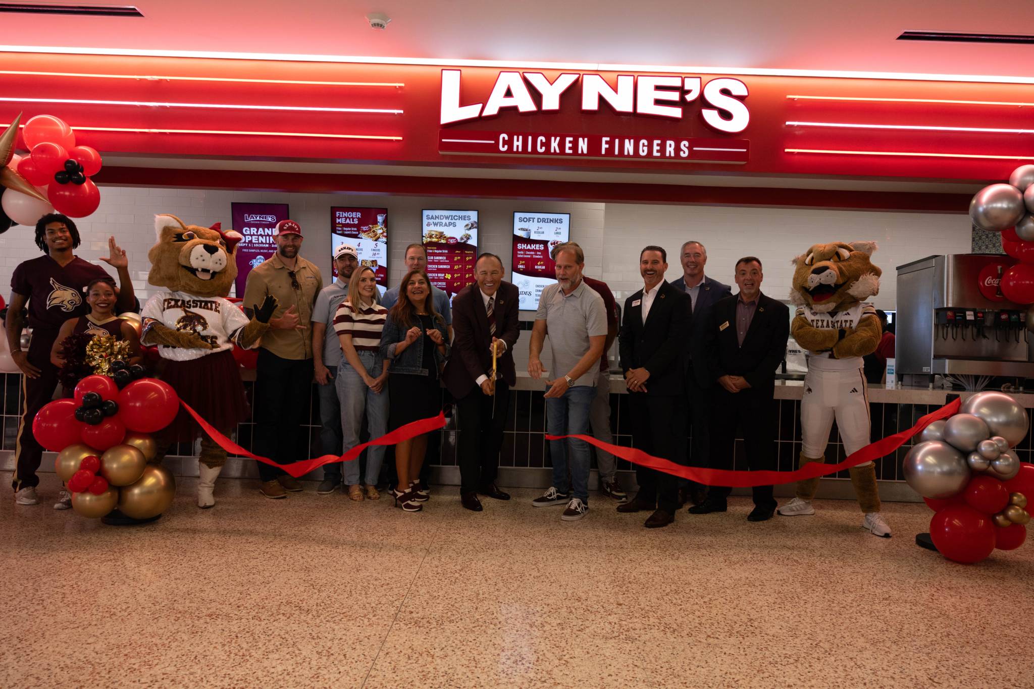 ribbon cutting with president, and txst hospitality staff