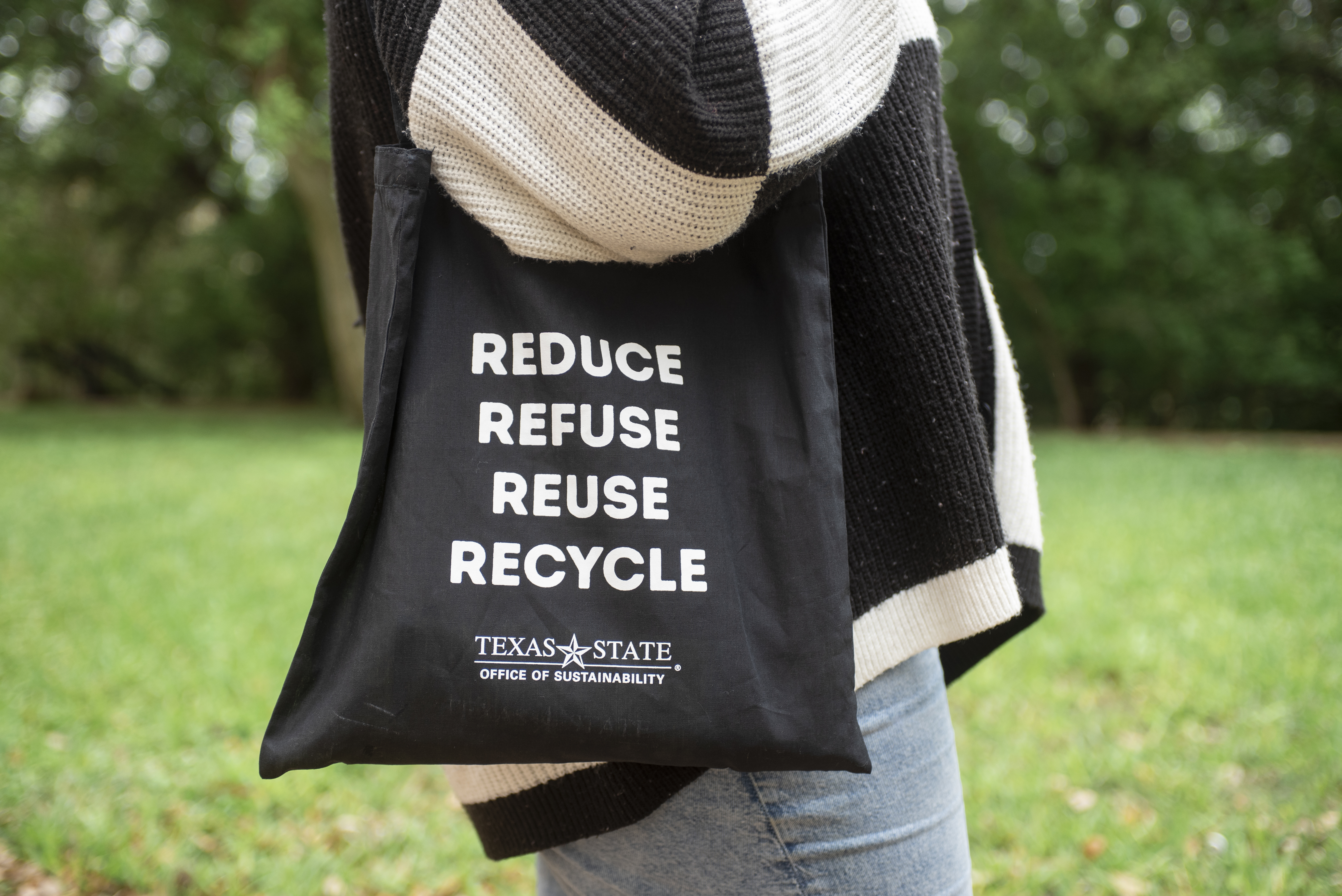 black tote bag reading "reduce refuse reuse recycle"
