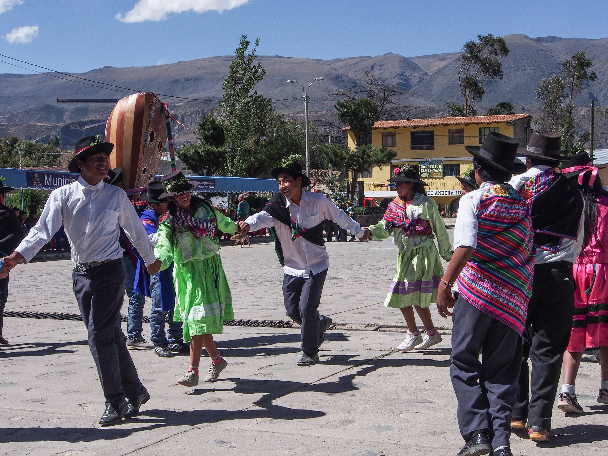 Peruvian people in colorful clothing dancing in the street