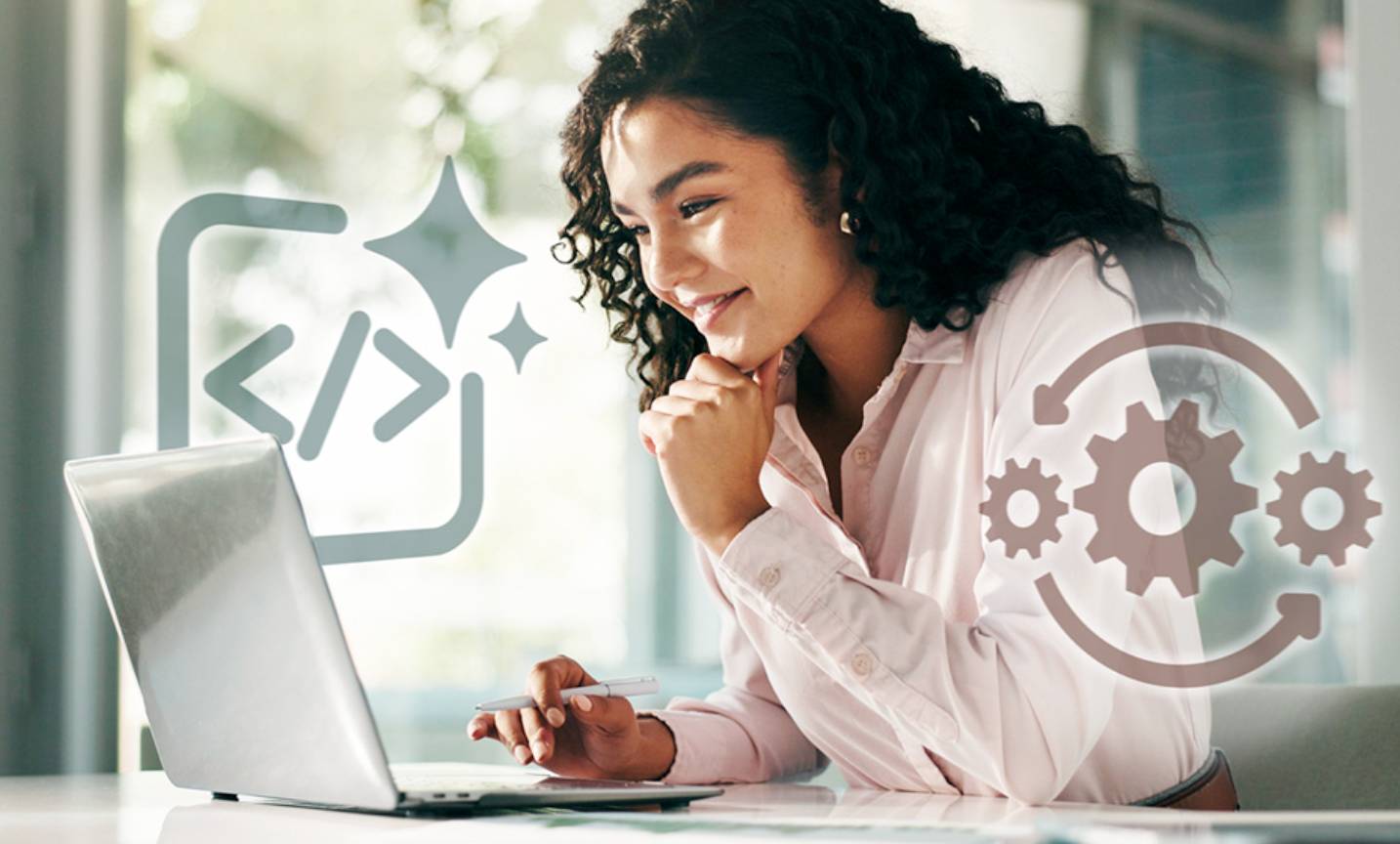 a seated woman looking at a laptop screen

