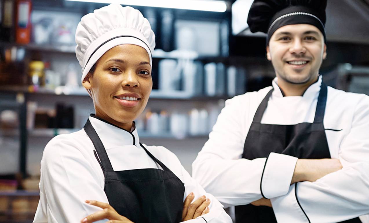 two chefs standing in a kitchen