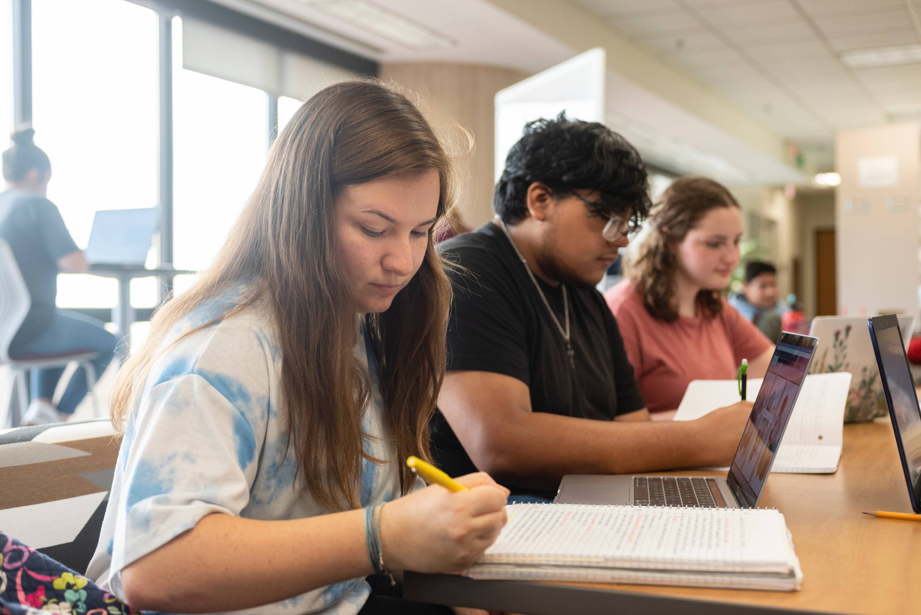 Student studying at tables in Alkek Library