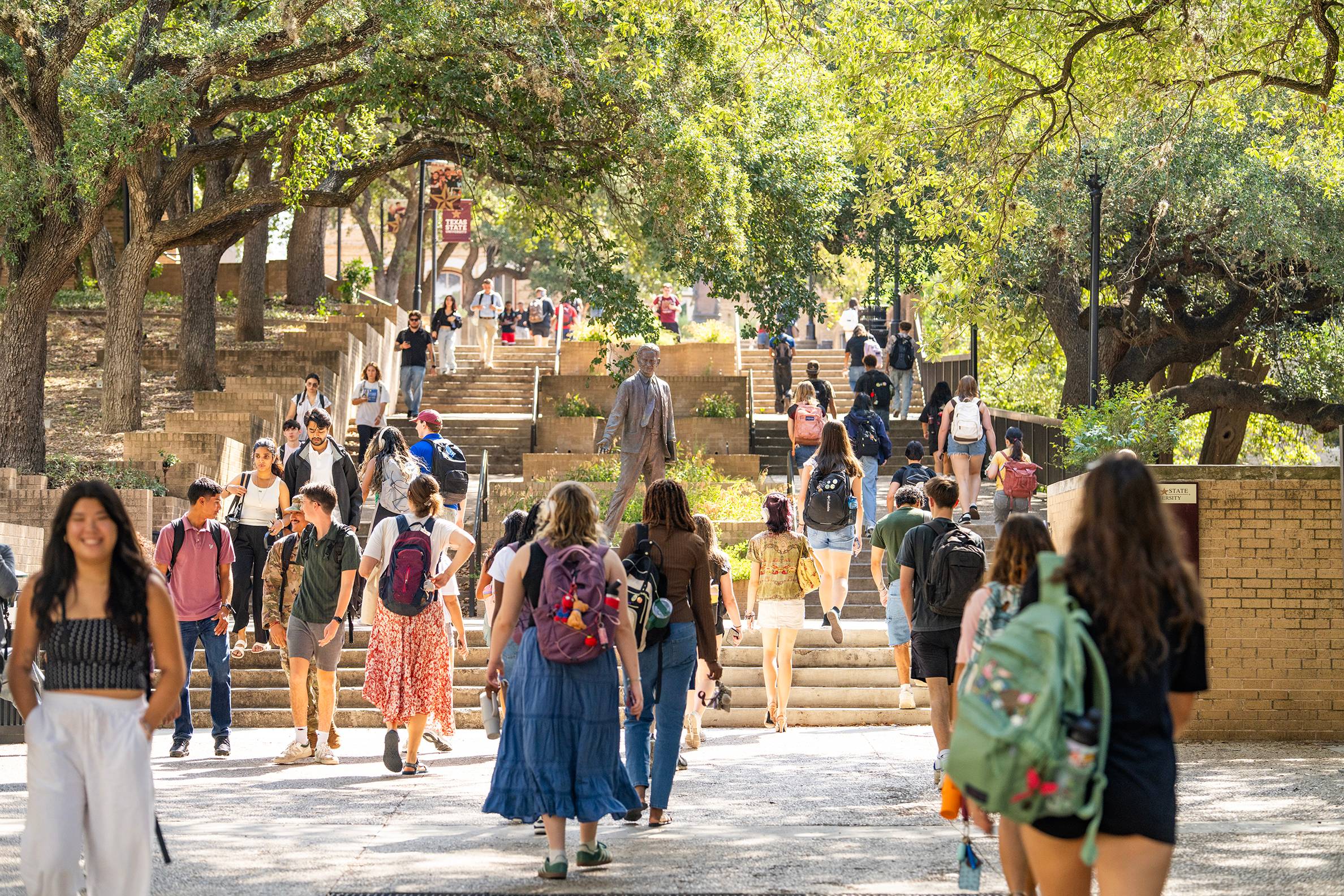 large group of students walking on campus