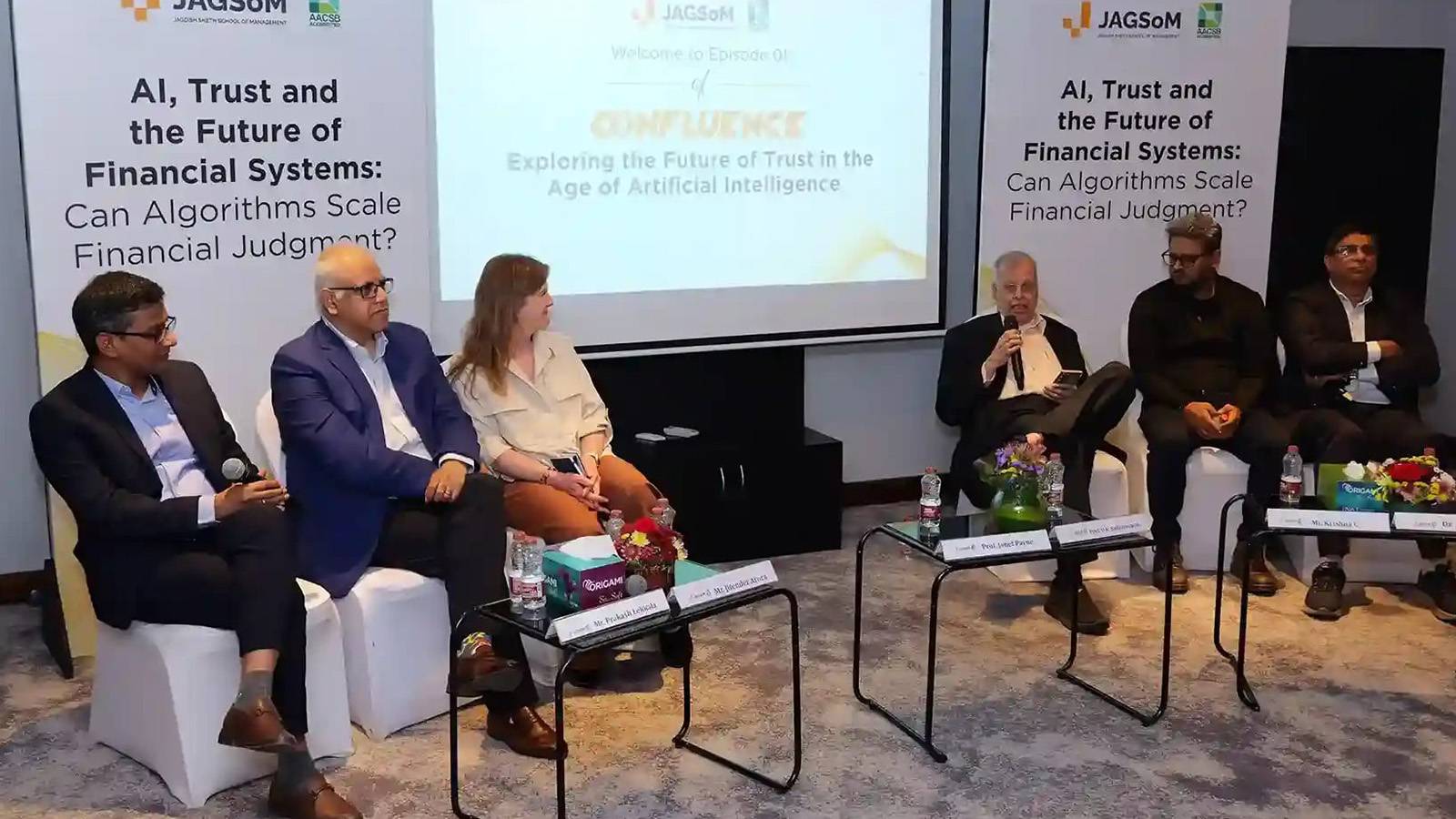 panel of six people sitting in chairs at a conference