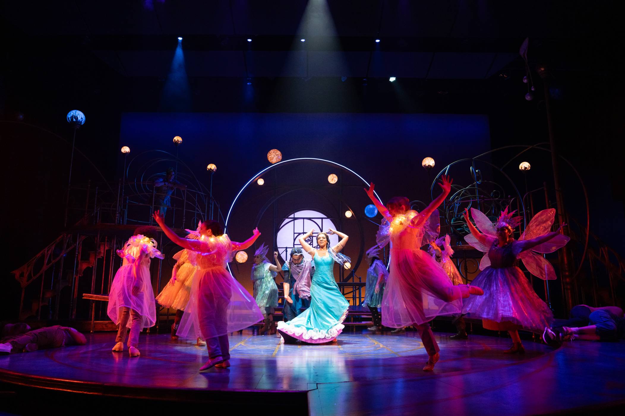 an array of people dancing on stage