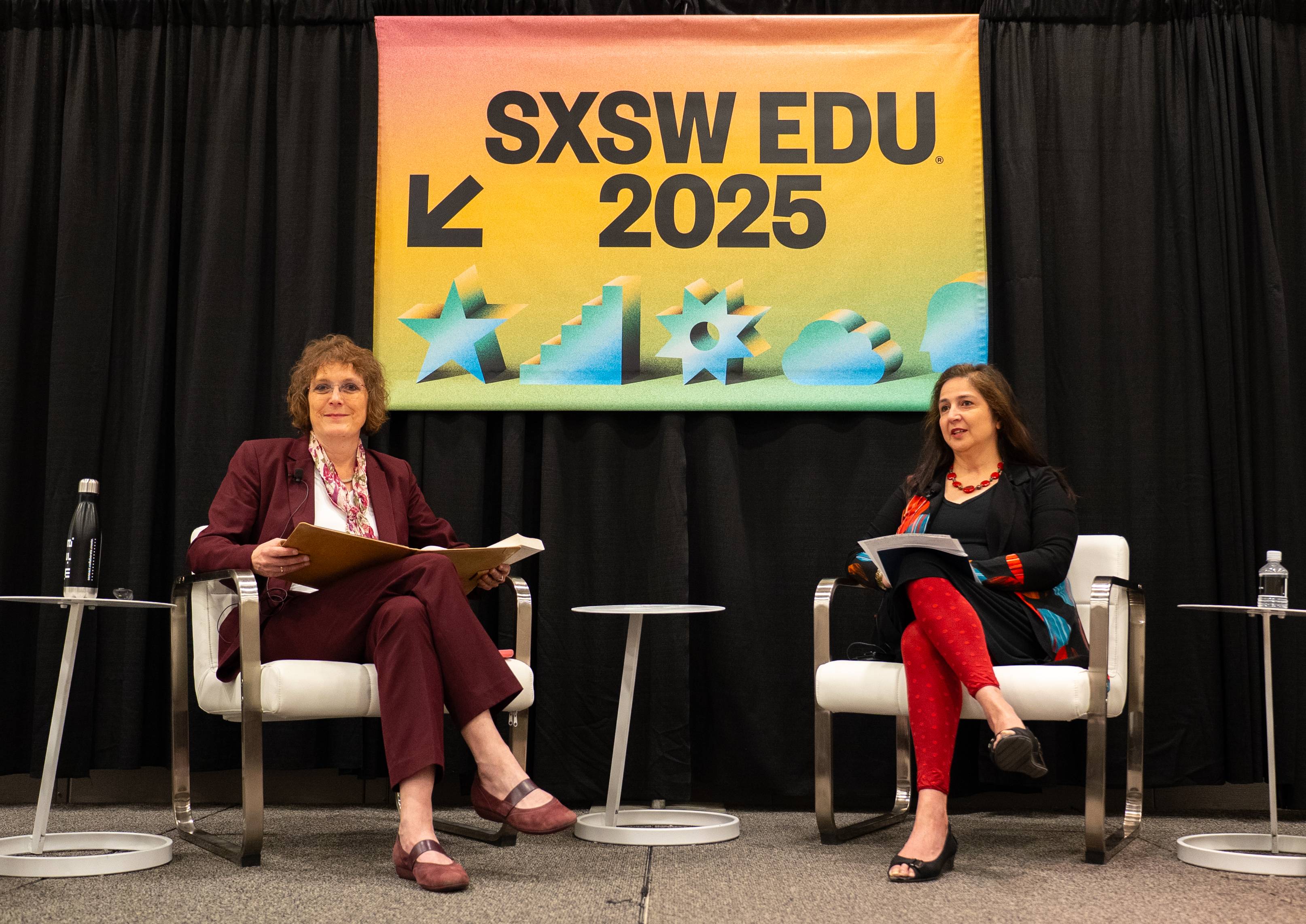 Two women participate in a discussion onstage at SXSW EDU 2025.