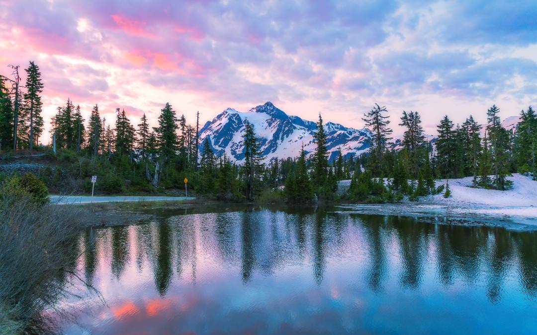 Seattle nature shot: mountains, trees, and a lake at sunset