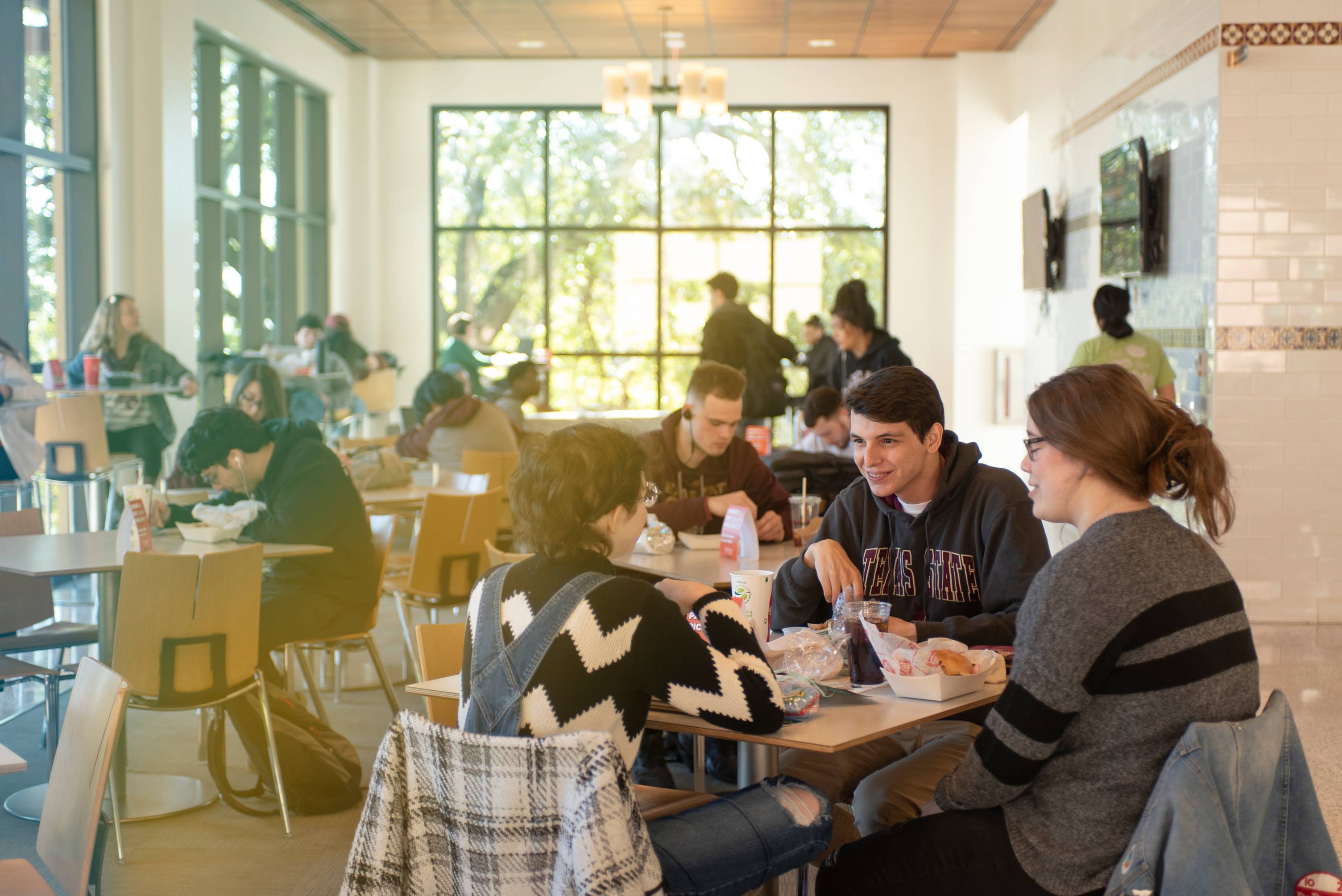 Students sitting in a dining hall at Texas State University