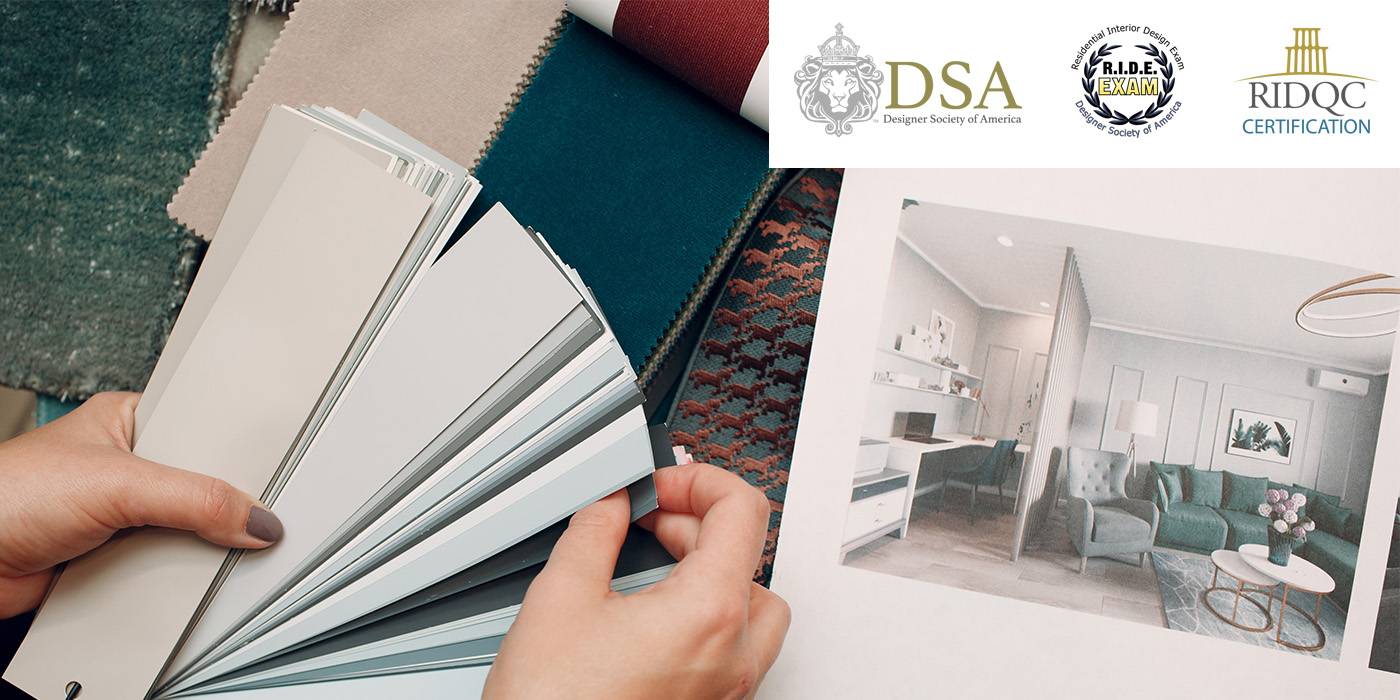 a person holds paint swatches over a desk with a living room pictured on a piece of paper