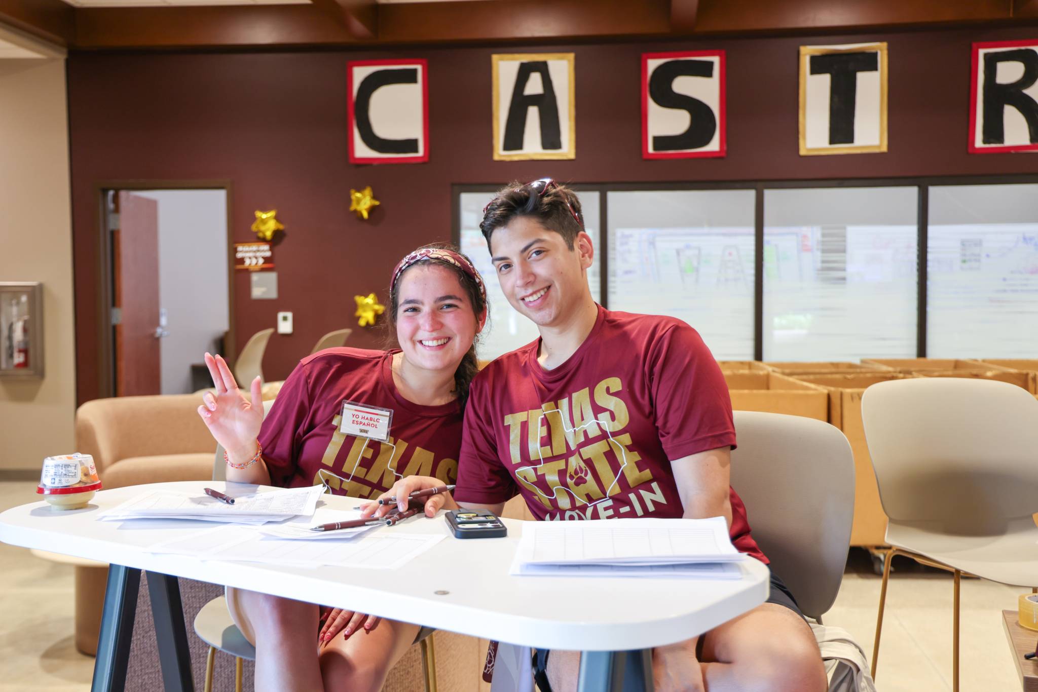 Two RAs at a check-in table during move in.