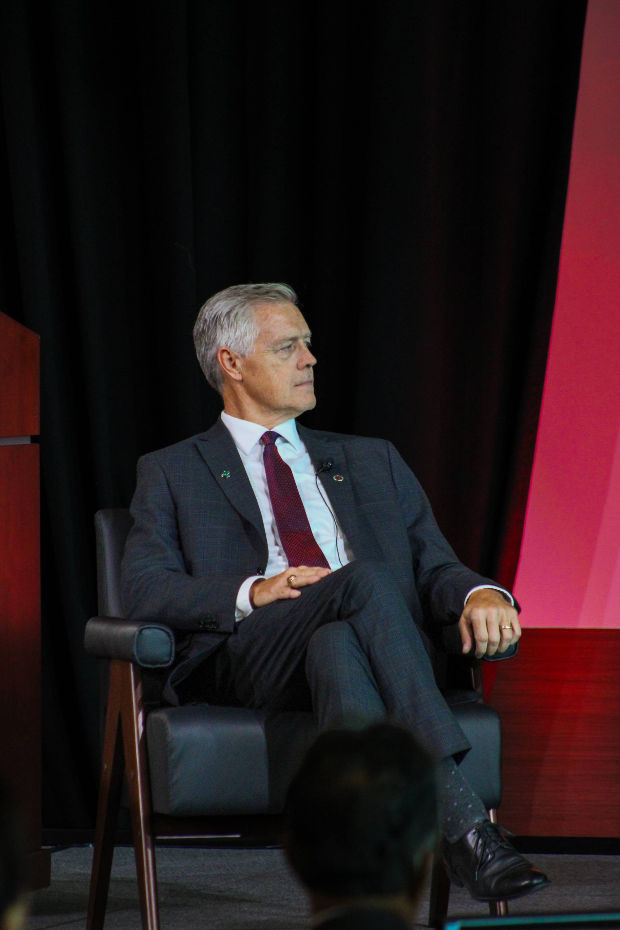 edward piner sitting in chair on stage