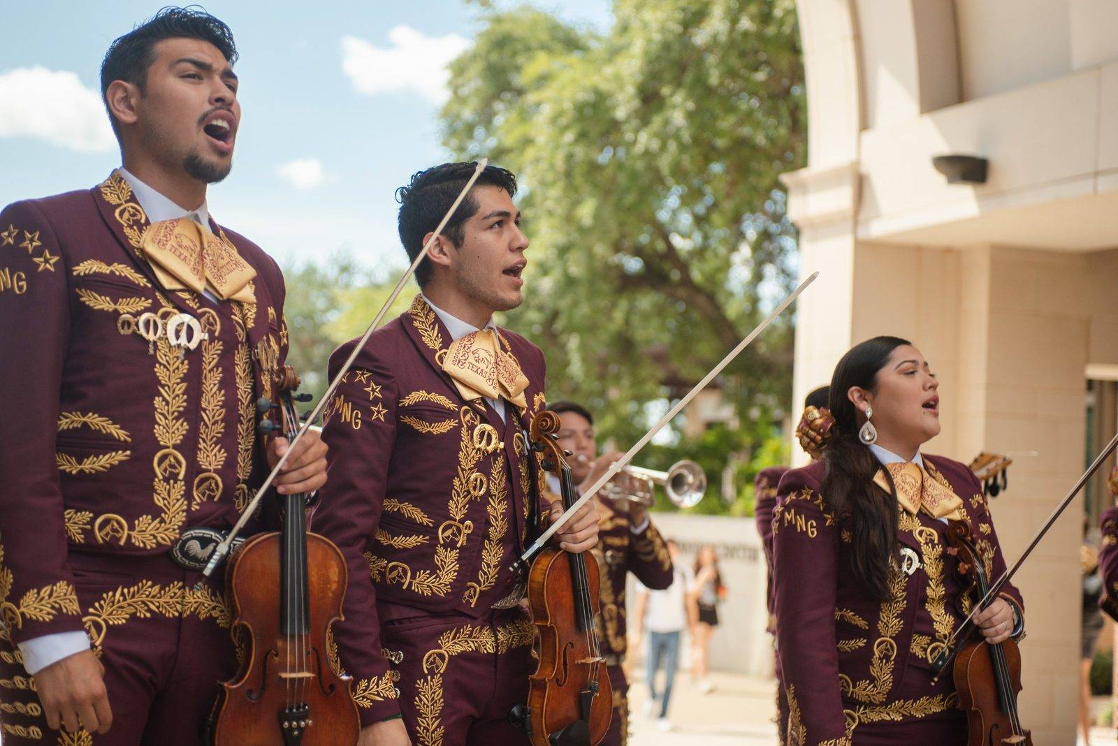 Mariachi students performing under the arch